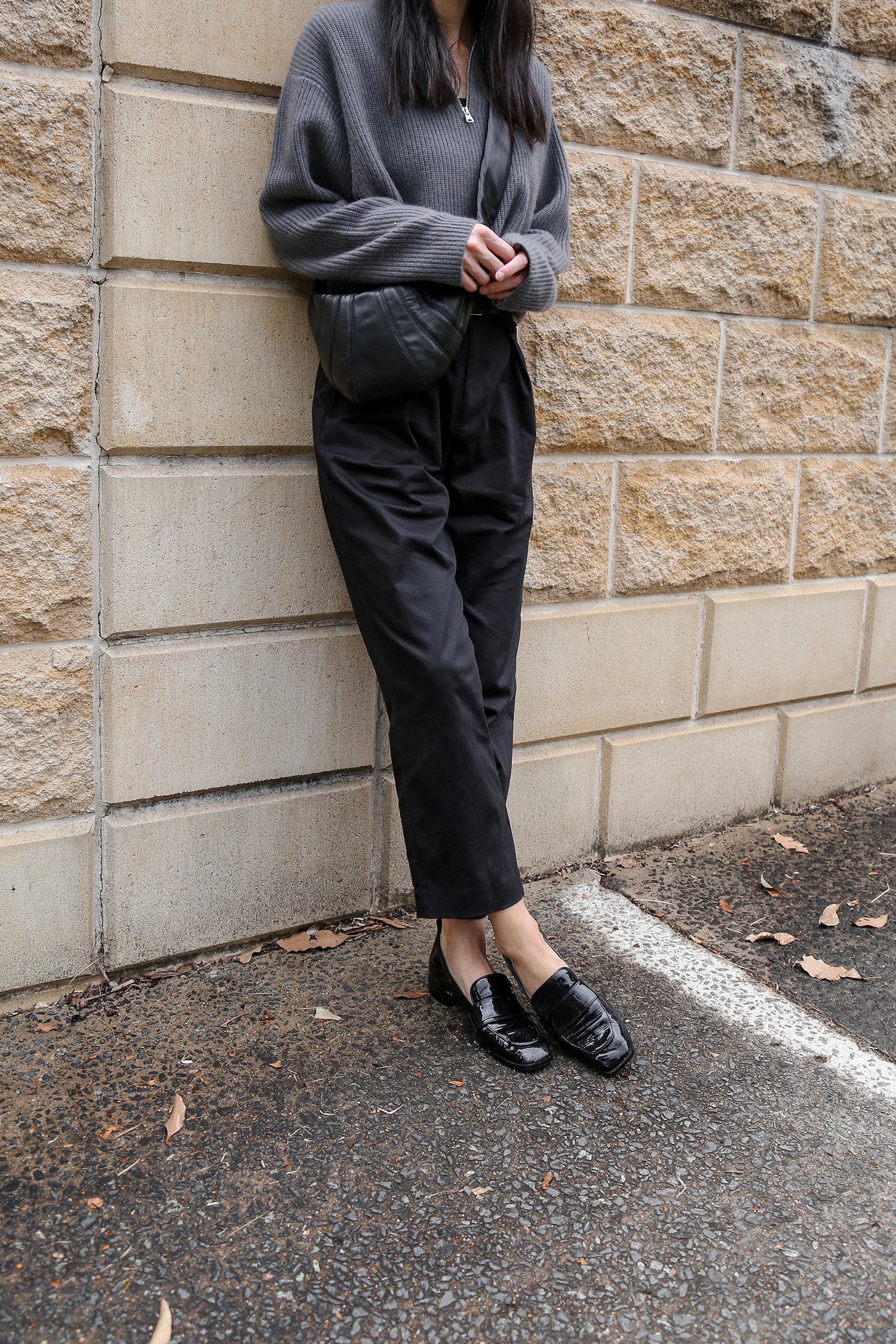 AERE the Label black cotton trousers and Aeyde patent loafers