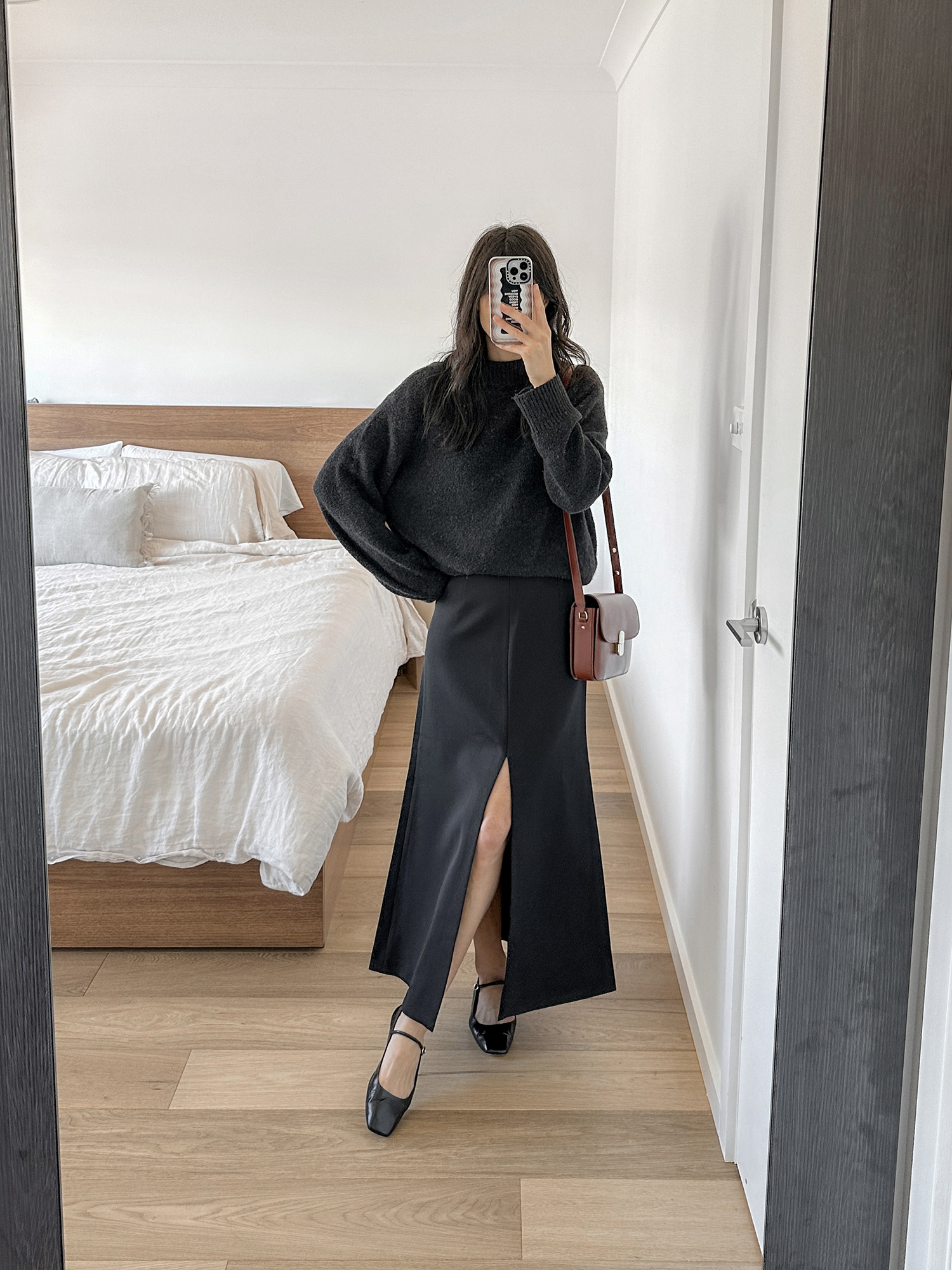 All black outfit with MAJ'R Label split skirt and Aeyde Uma flats