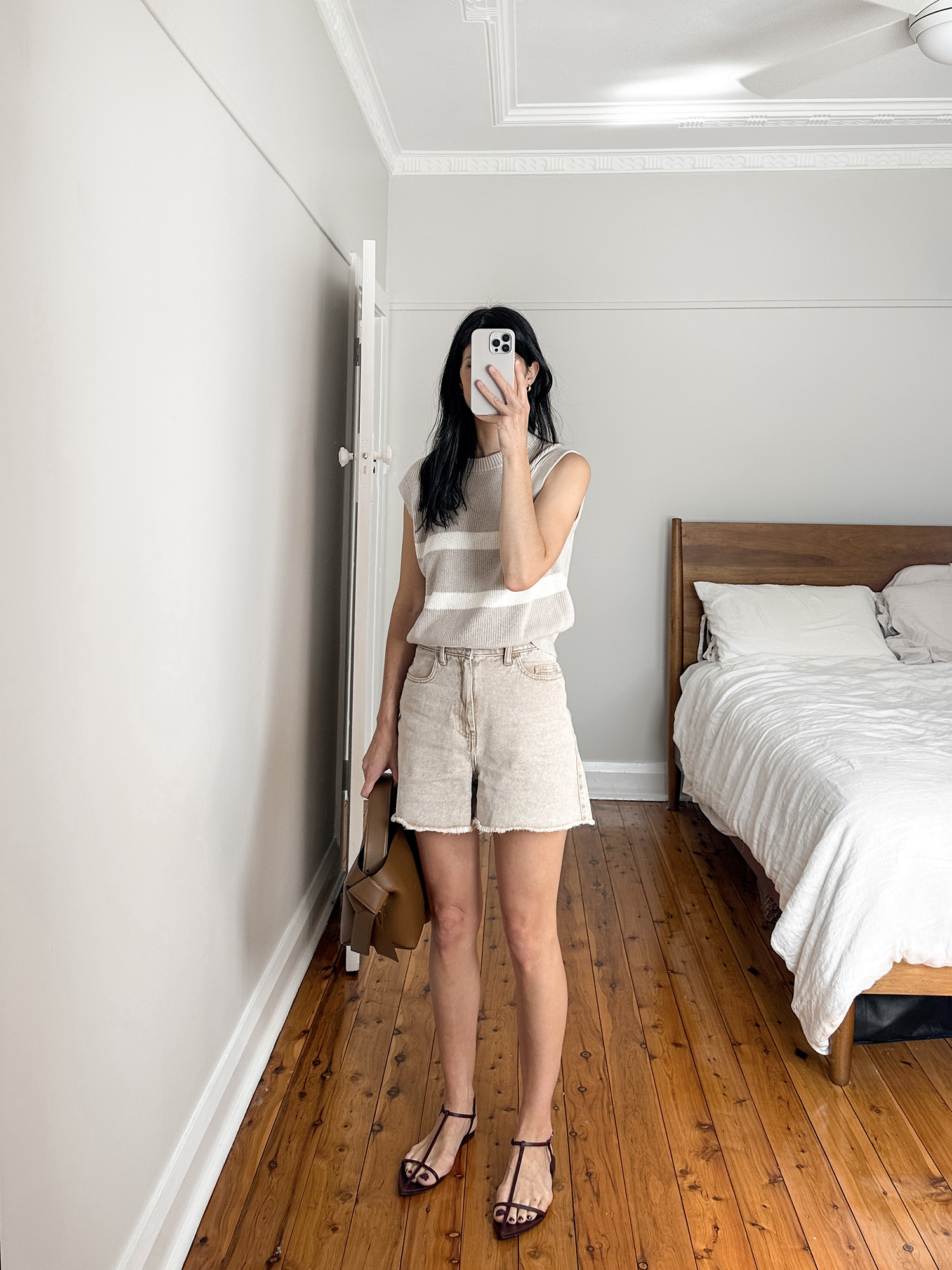 Beige outfit Inspo wearing striped knit tank with Viktoria Woods thunderbird shorts and Jil Sander agnoletto sandals