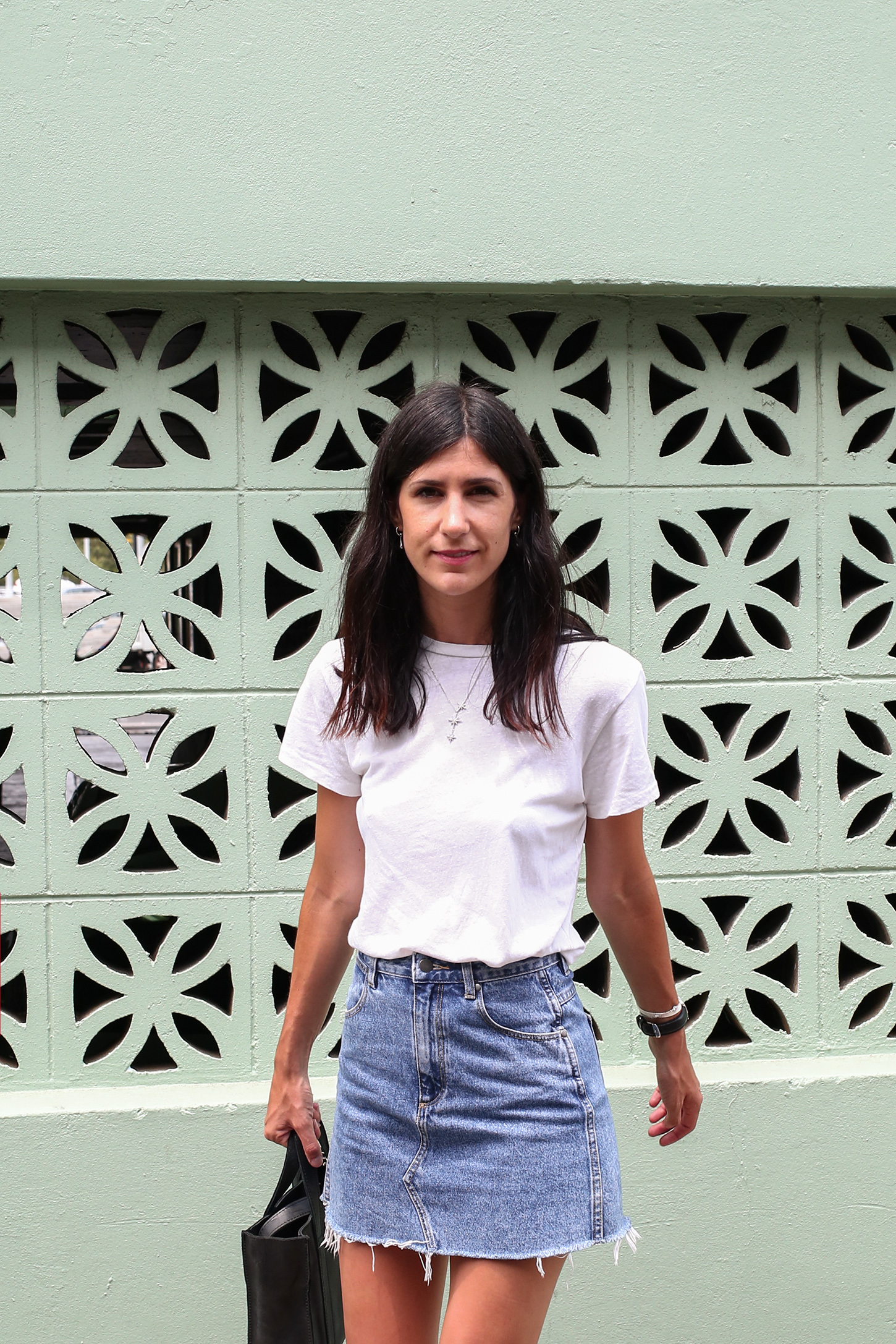 Friday Finds wearing a white tee and denim skirt