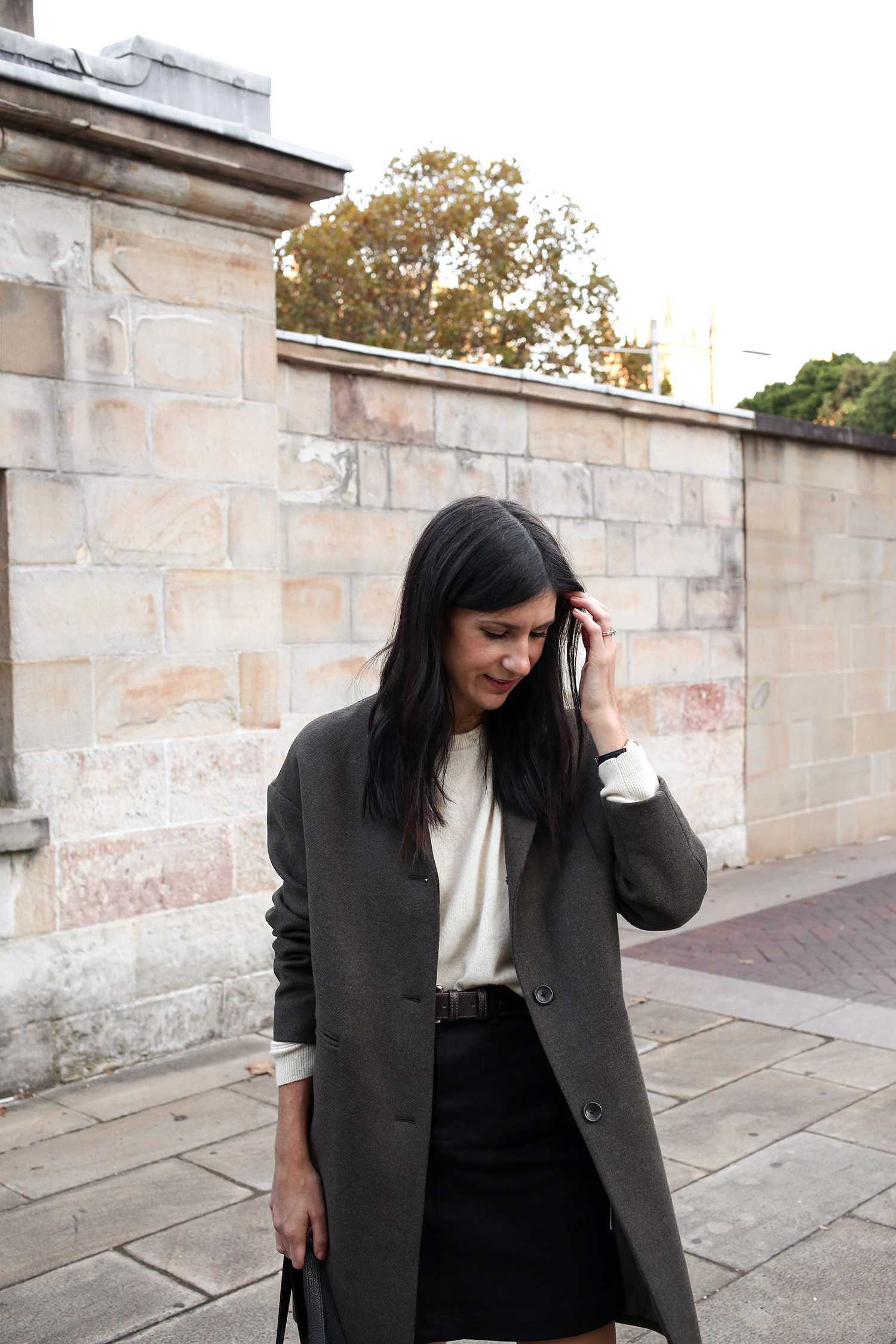 Jamie Lee Mademoiselle wearing an Autumn Minimal Style Outfit of a cashmere sweater with mini skirt and boots