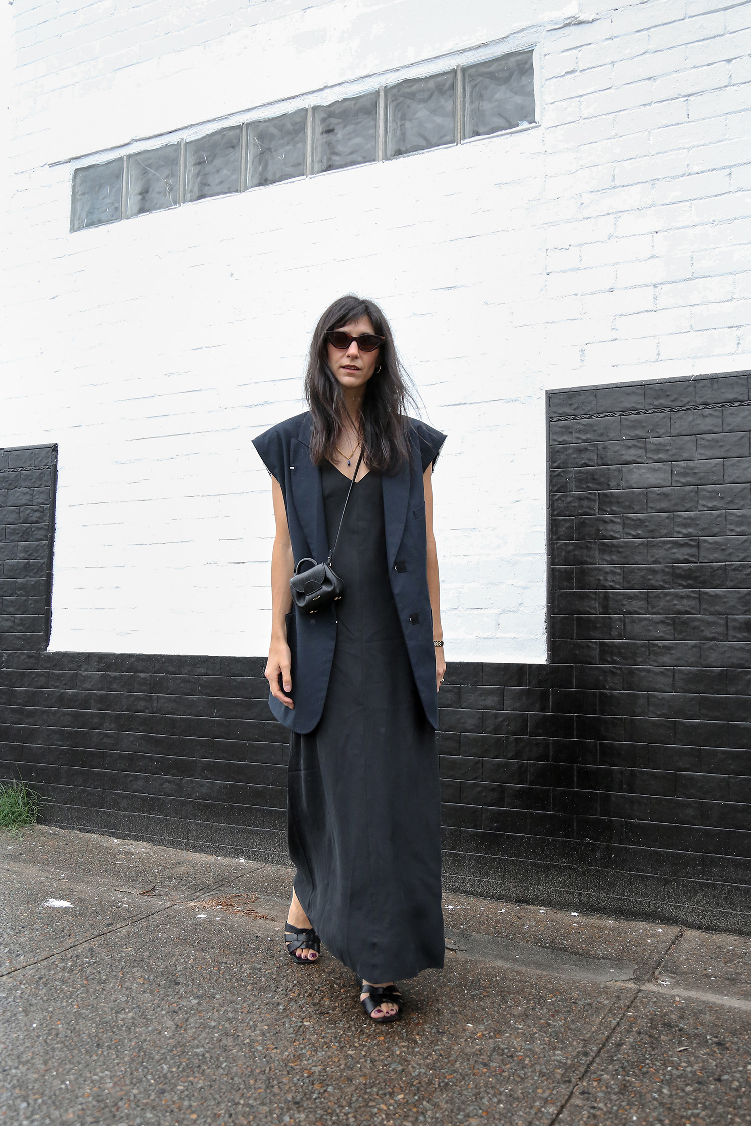 Minimal all black outfit with slip dress and sleeveless blazer summer layering