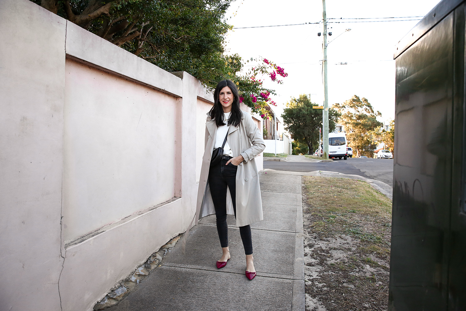 Jamie Lee of Mademoiselle wearing a minimal outfit with red shoes