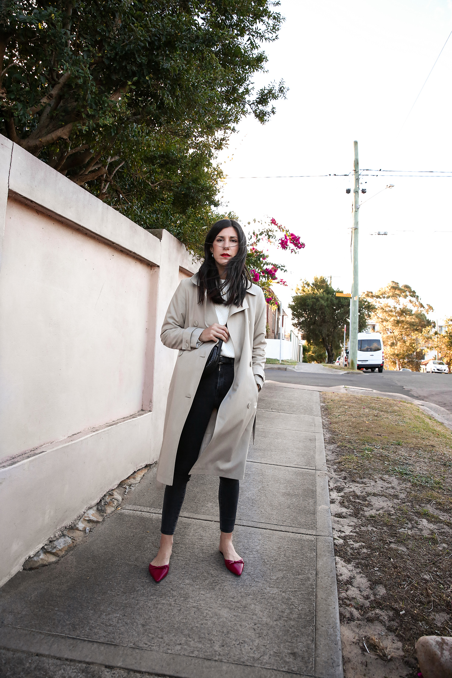 Jamie Lee of Mademoiselle wearing a minimal outfit with red shoes