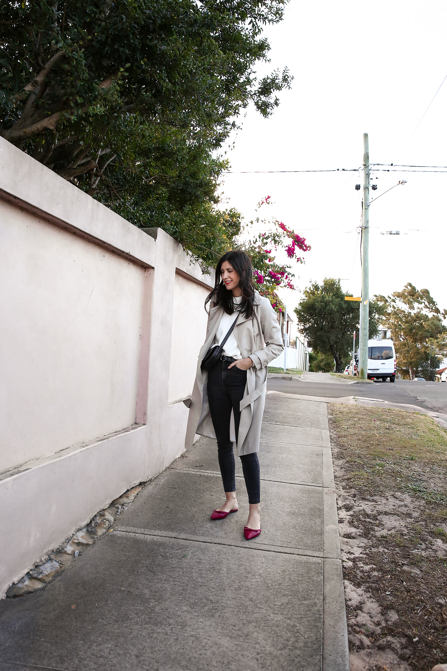 Jamie Lee of Mademoiselle wearing a minimal outfit with red shoes