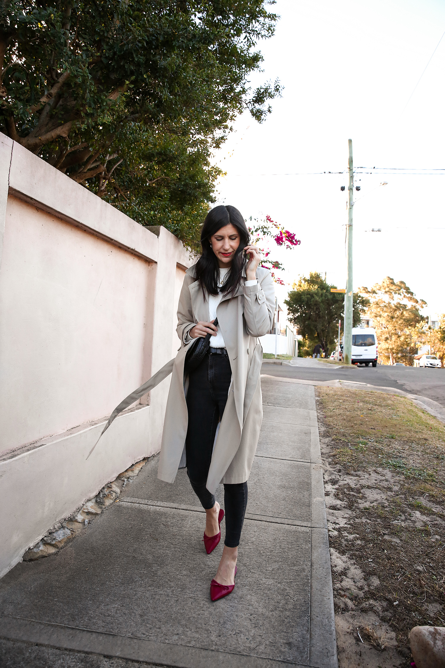 Jamie Lee of Mademoiselle wearing a minimal outfit with red shoes