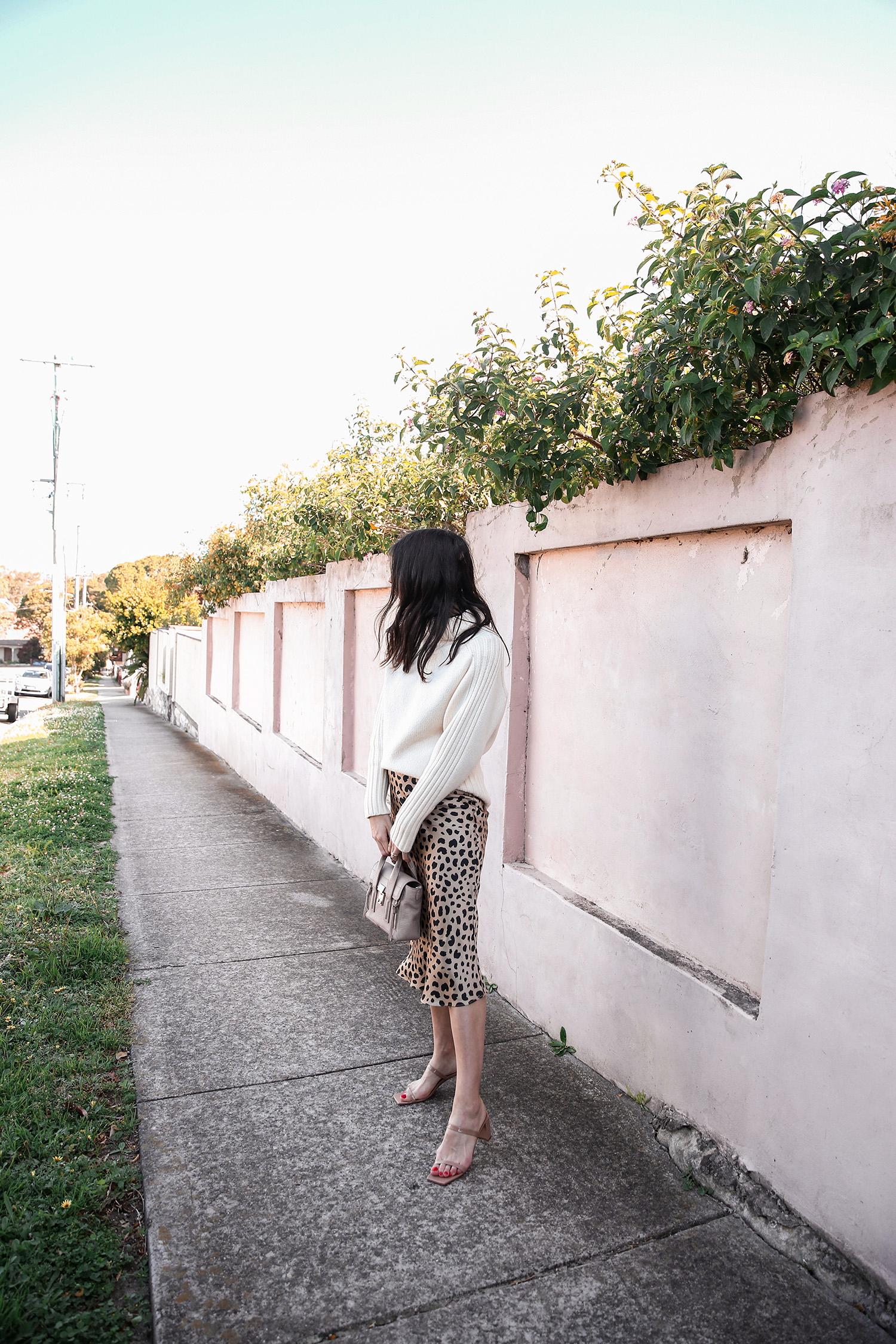 Outfit wearing white rollneck sweater and leopard silk slip skirt
