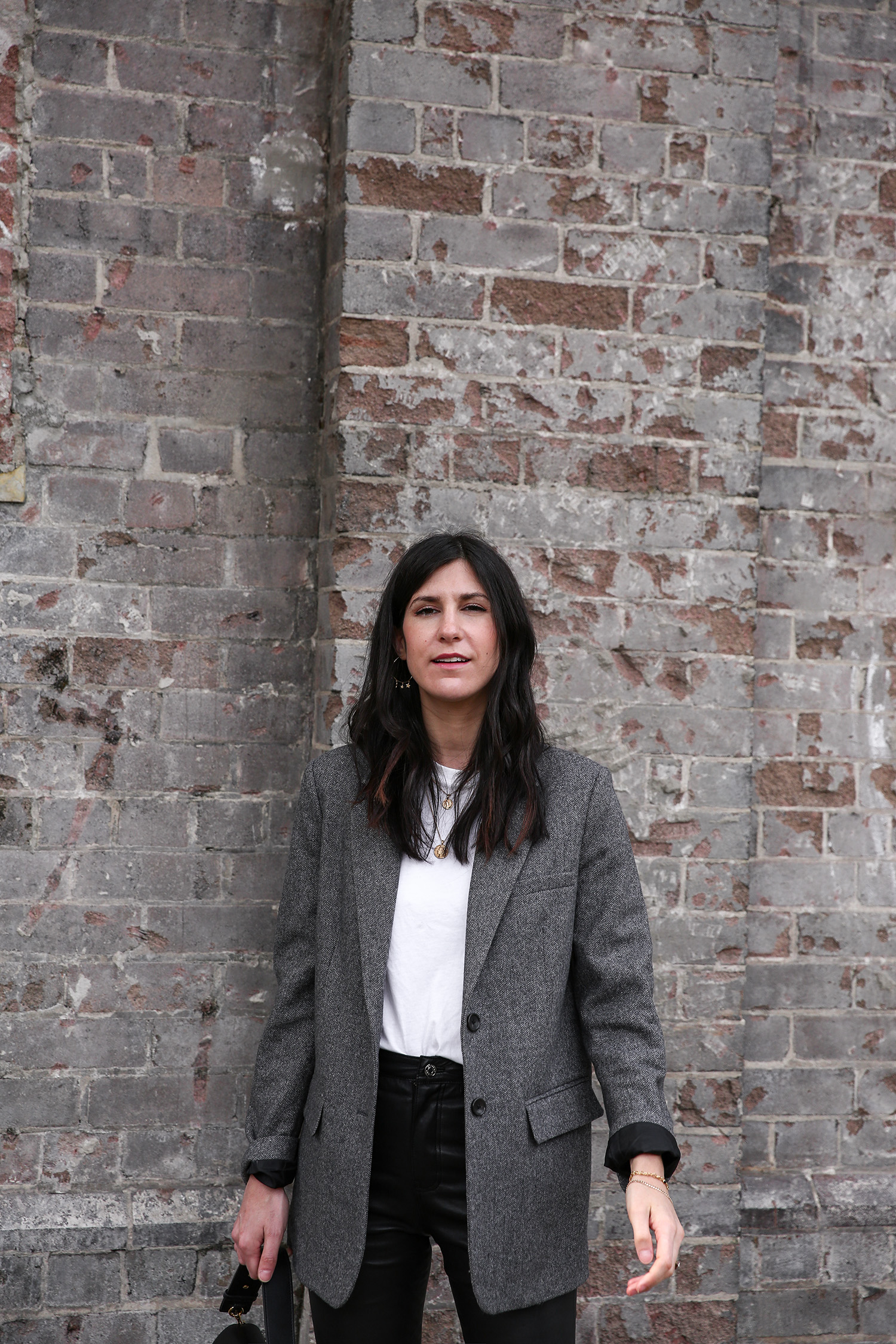 Jamie Lee of Mademoiselle wearing the Everlane oversized blazer and GRLFRND Denim leather trousers