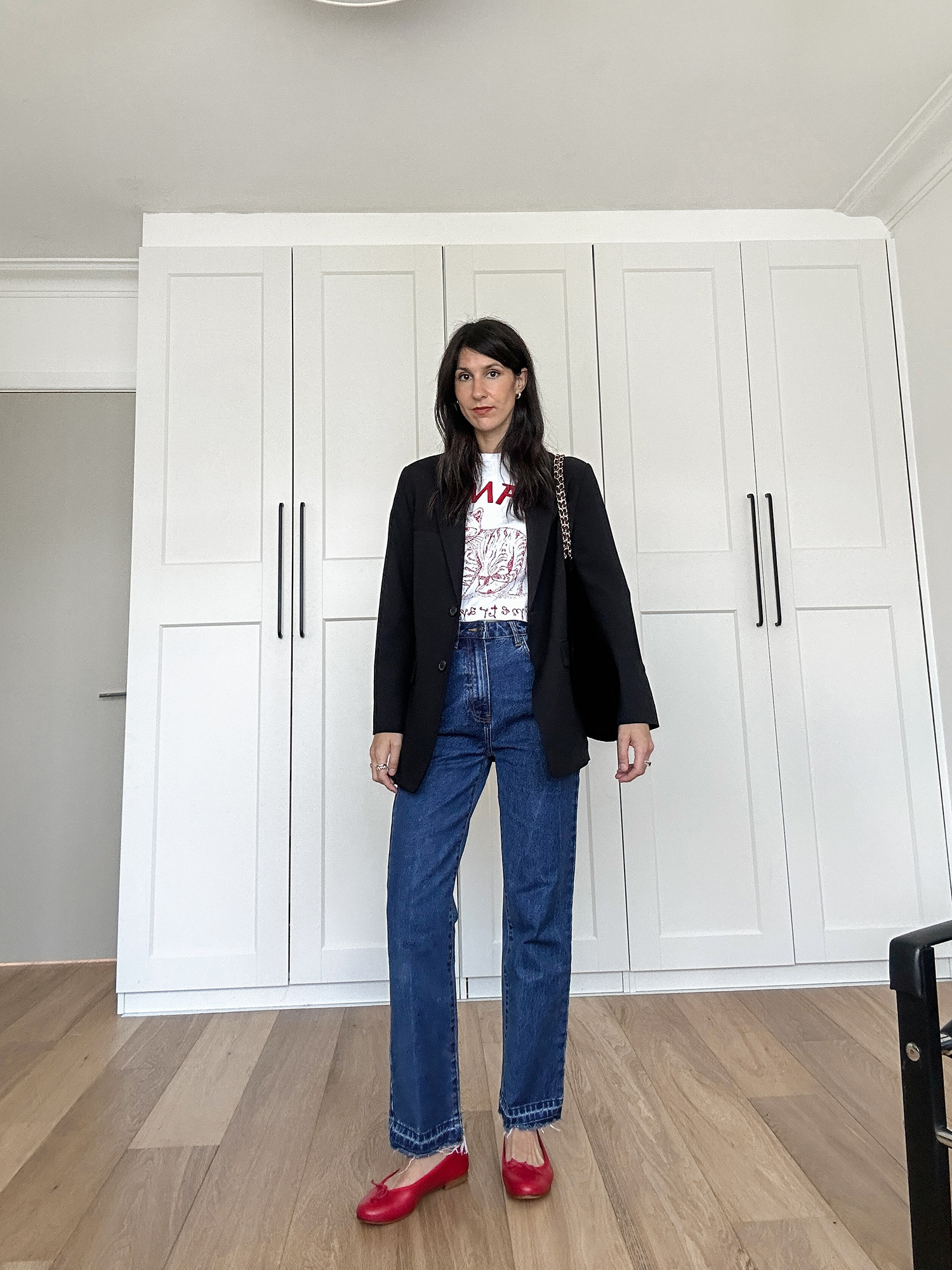 Classic French outfit with blazer and jeans and red ballet flats