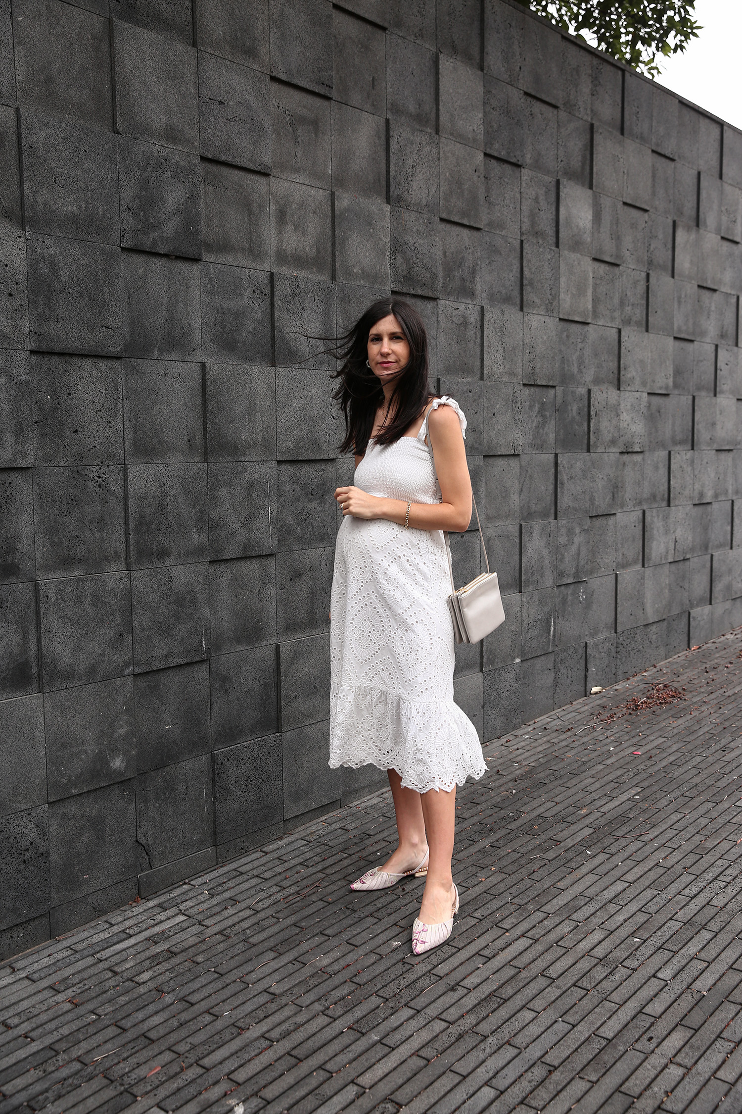 Jamie Lee of Mademoiselle wearing a Farrow broderie anglaise dress and Zimmermann flats
