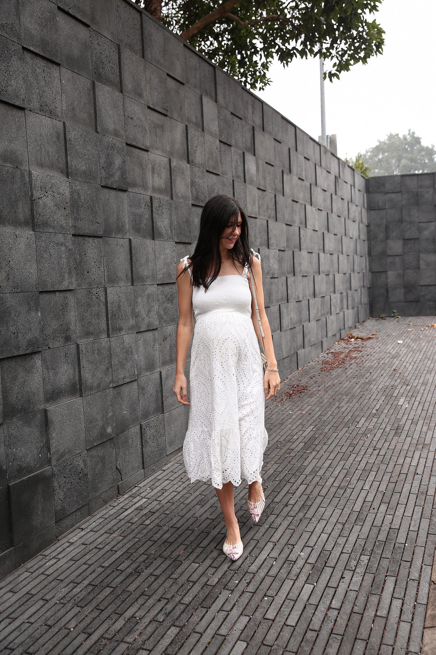 Jamie Lee of Mademoiselle wearing a Farrow broderie anglaise dress and Zimmermann flats