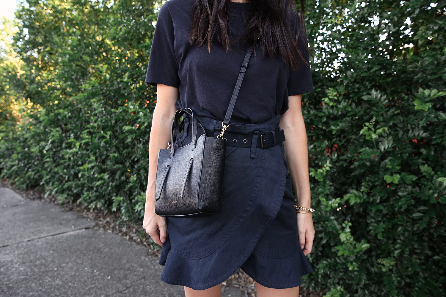 Jamie Lee of Mademoiselle wearing an Everlane black tee and Isabel Marant ruffled skirt