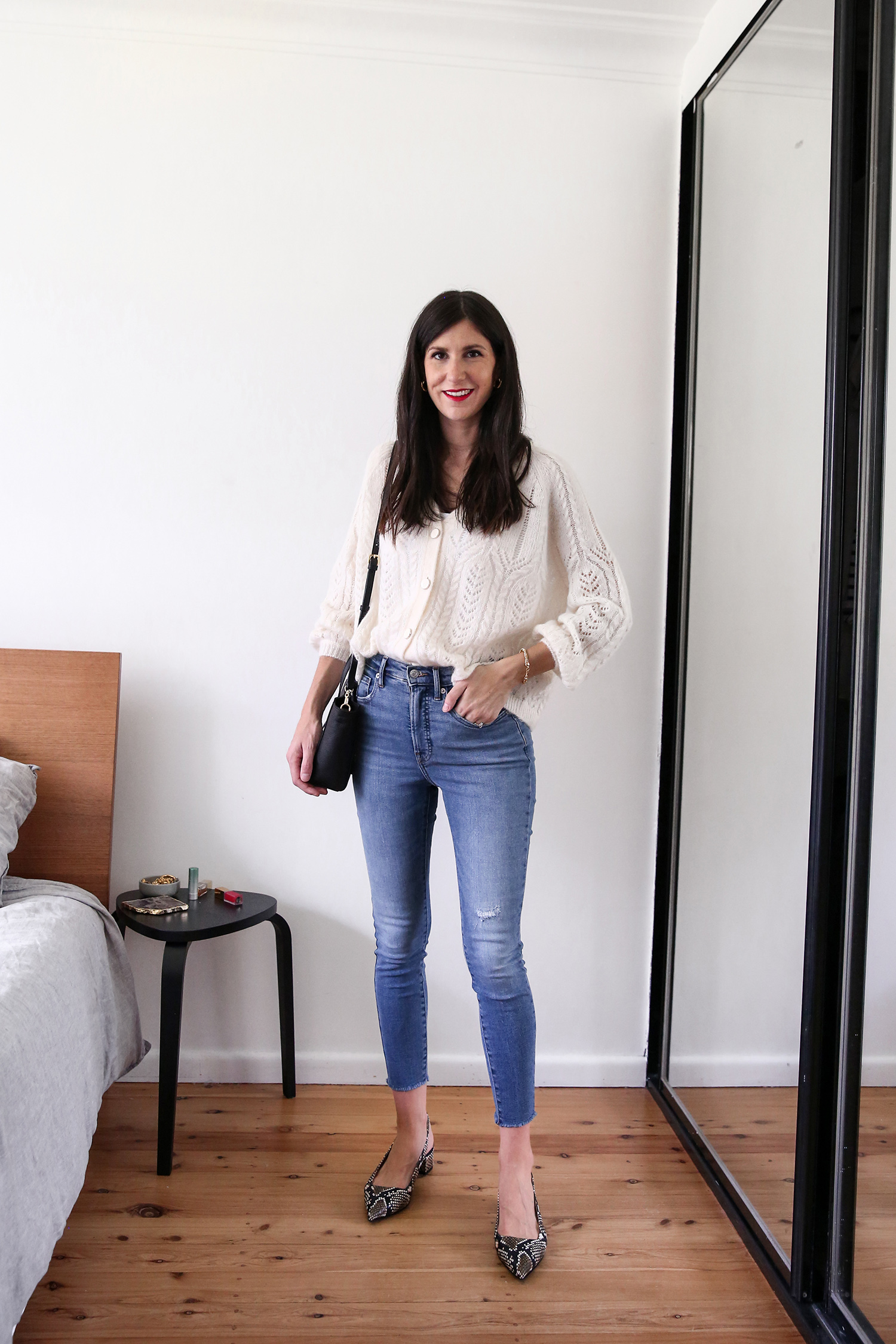 Jamie Lee of Mademoiselle wearing a Parisian Style outfit of a cardigan tucked into skinny jeans with low block heels