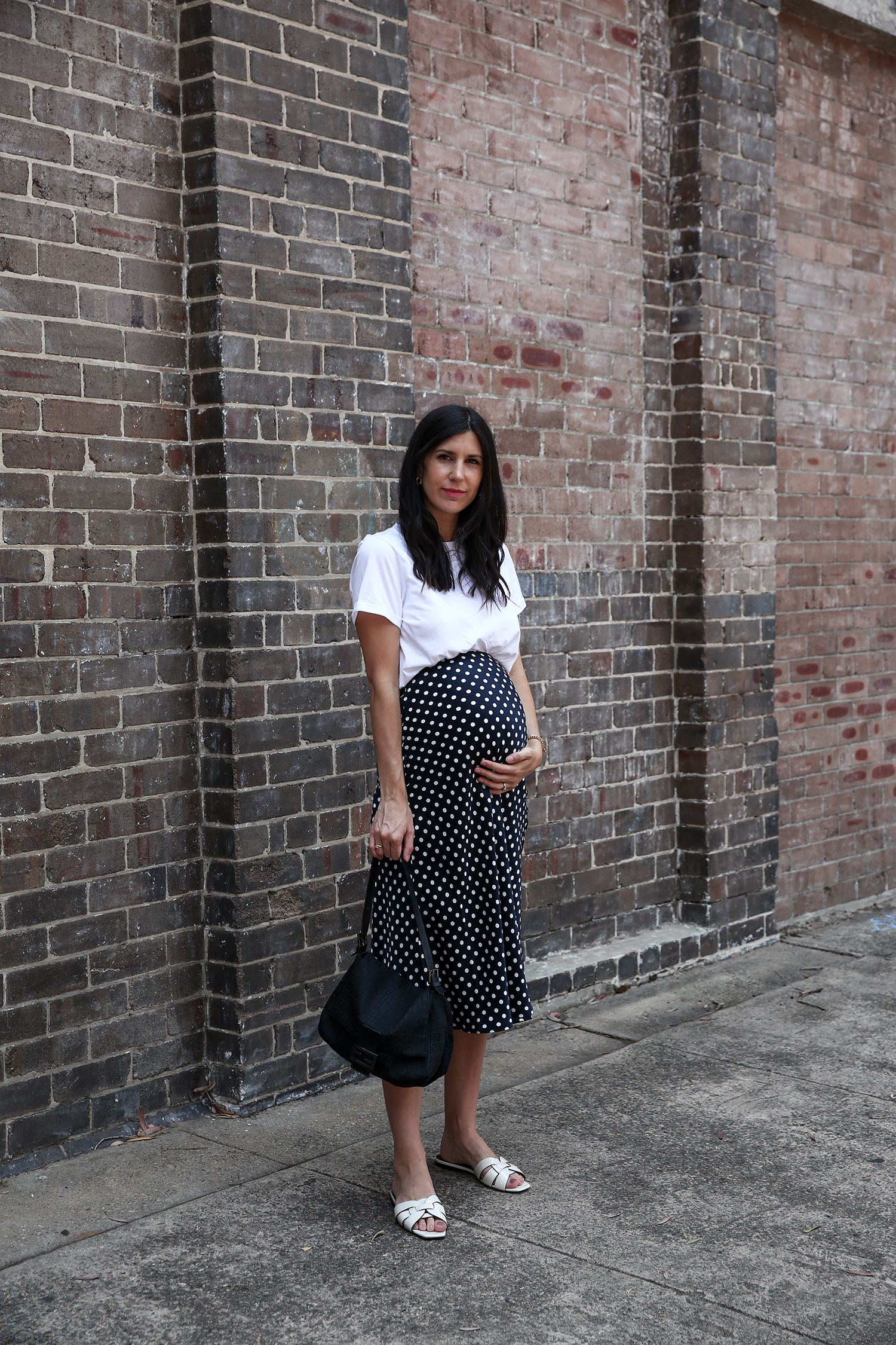 Navy polka dot skirt worn with Saint Laurent Nu Pieds Sandals