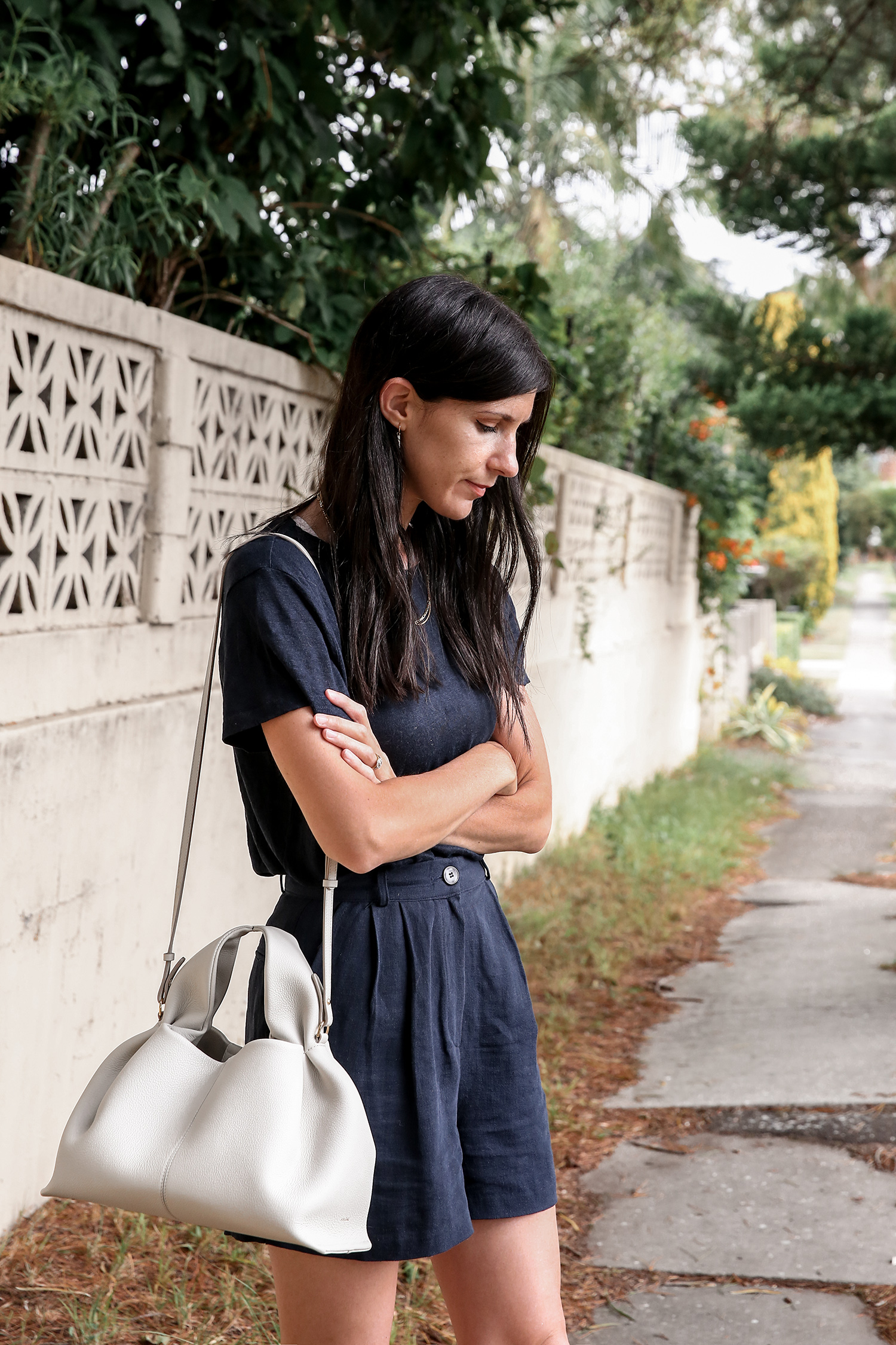 All navy outfit street style with white shoulder bag