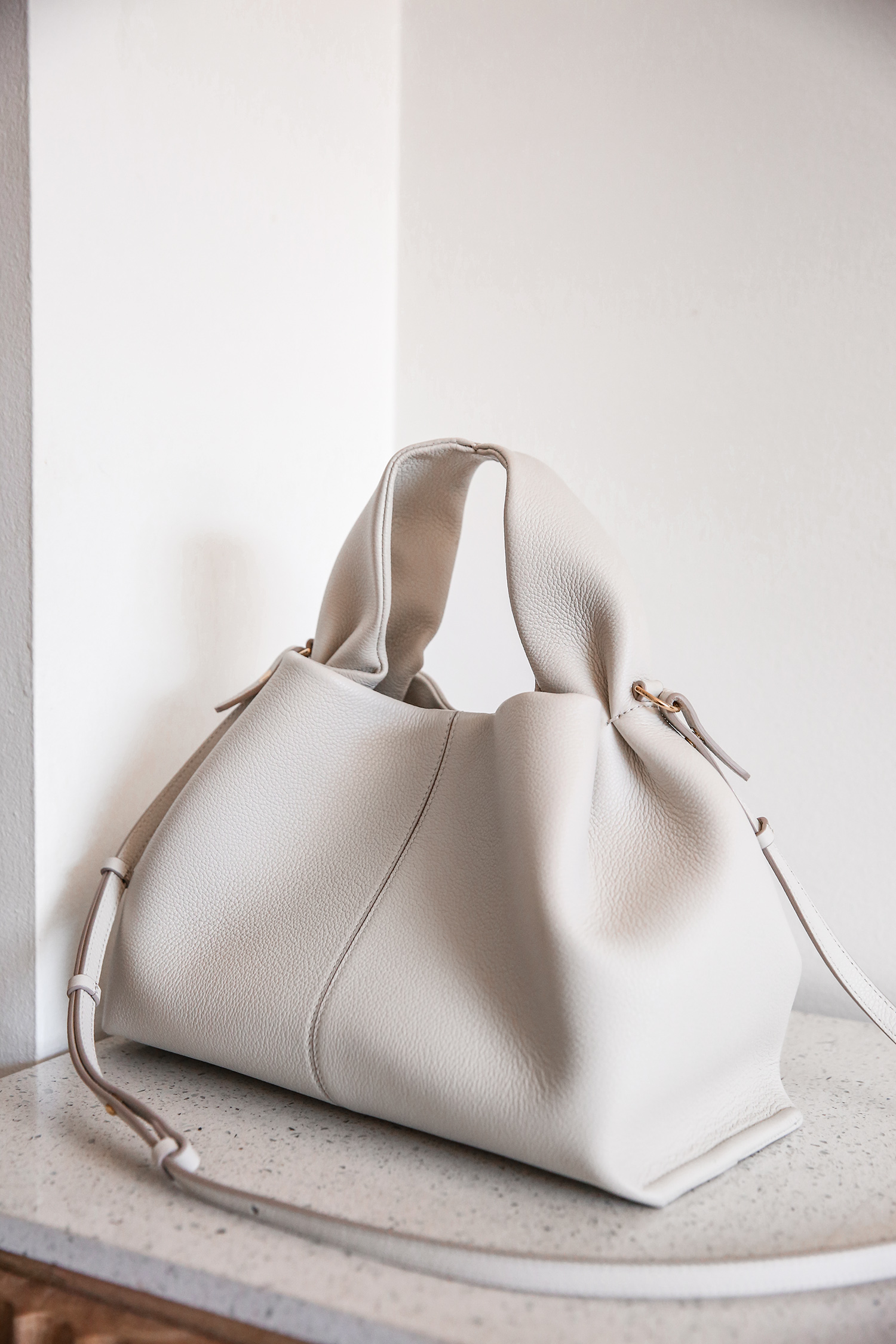 The Polene Neuf bag in Chalk (right) and Taupe (left) color are