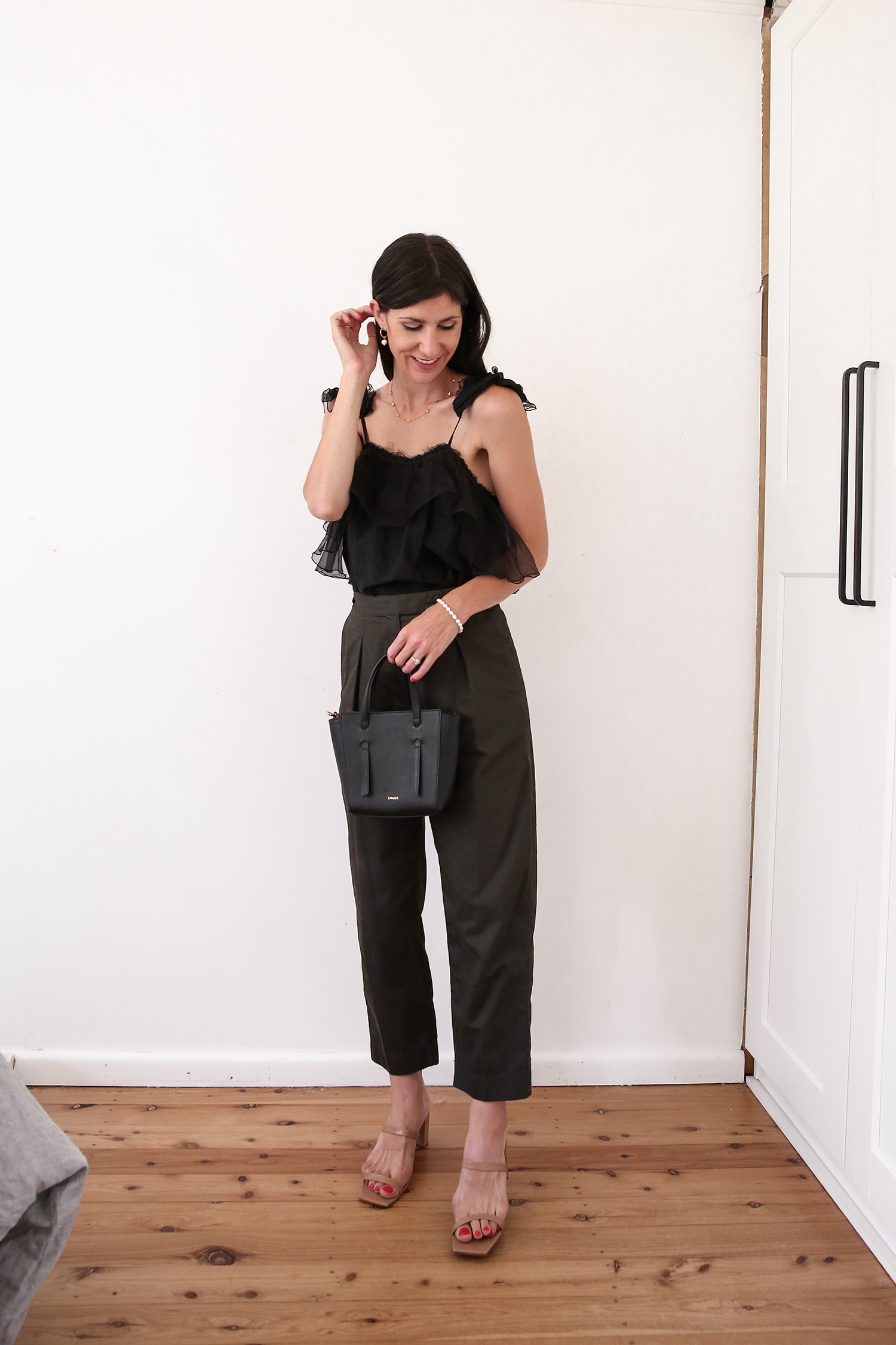 Aje ruffle top with Arket cotton trousers and By Far mules