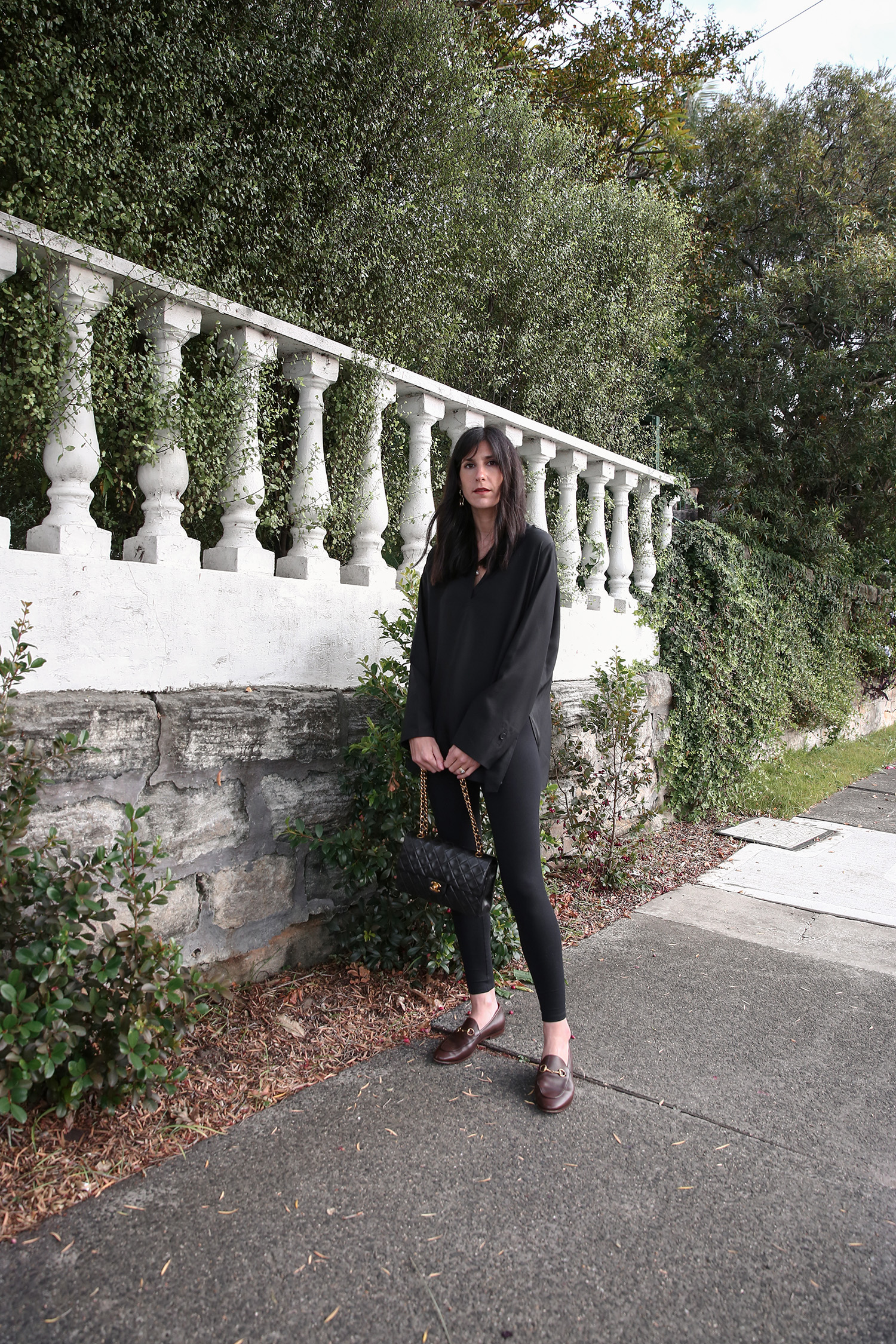 Minimal Style Scandi monochrome outfit wearing COS black silk kaftan and Gucci Loafers