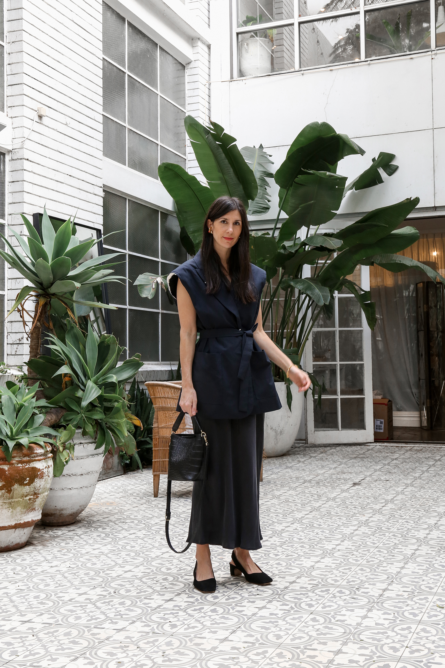 Wearing RAEY oversized sleeveless jacket with Marle silk skirt and By Far Danielle pumps