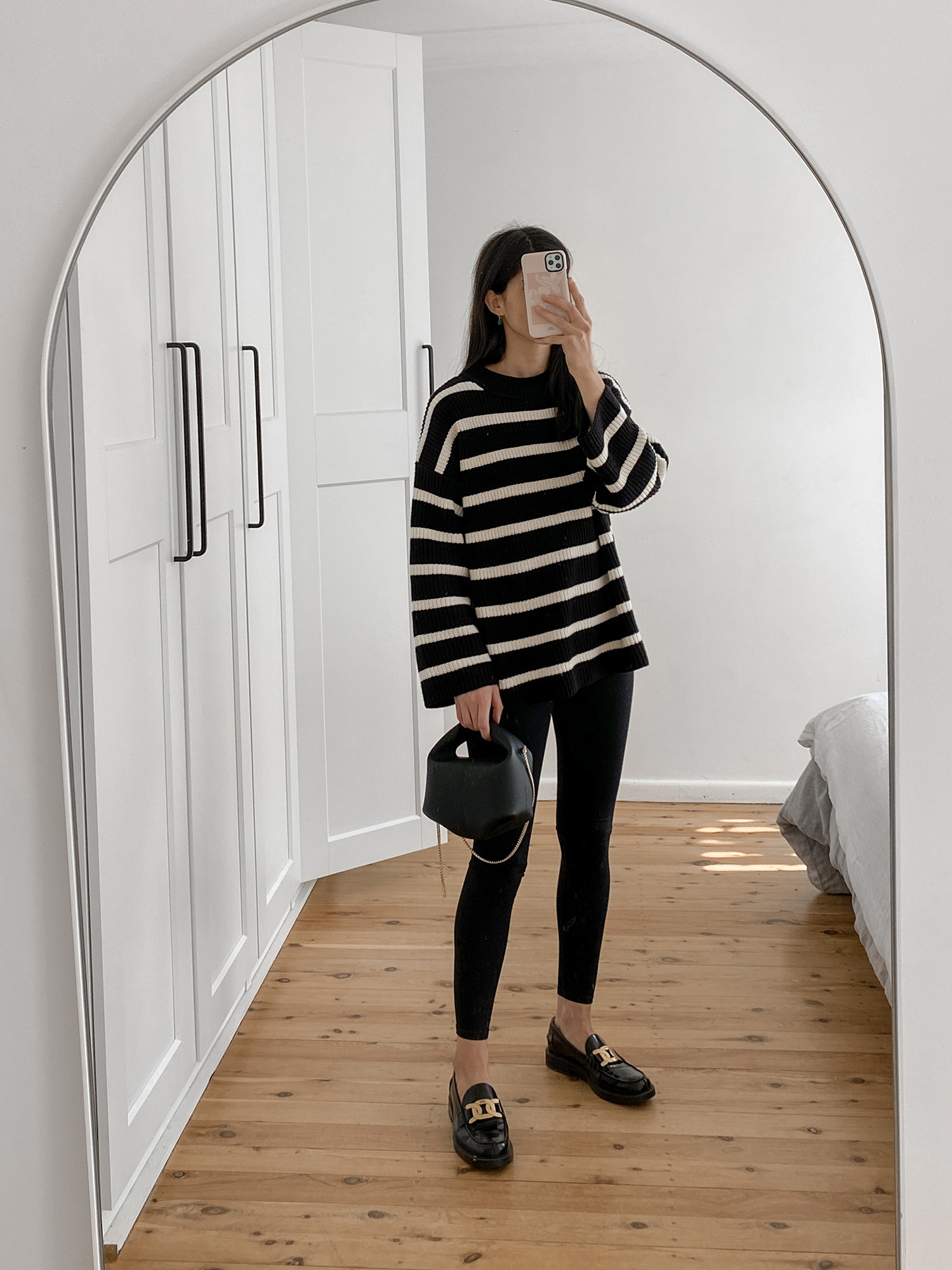 Minimal Parisian Style Outfit wearing striped knit with leggings and chunky loafers