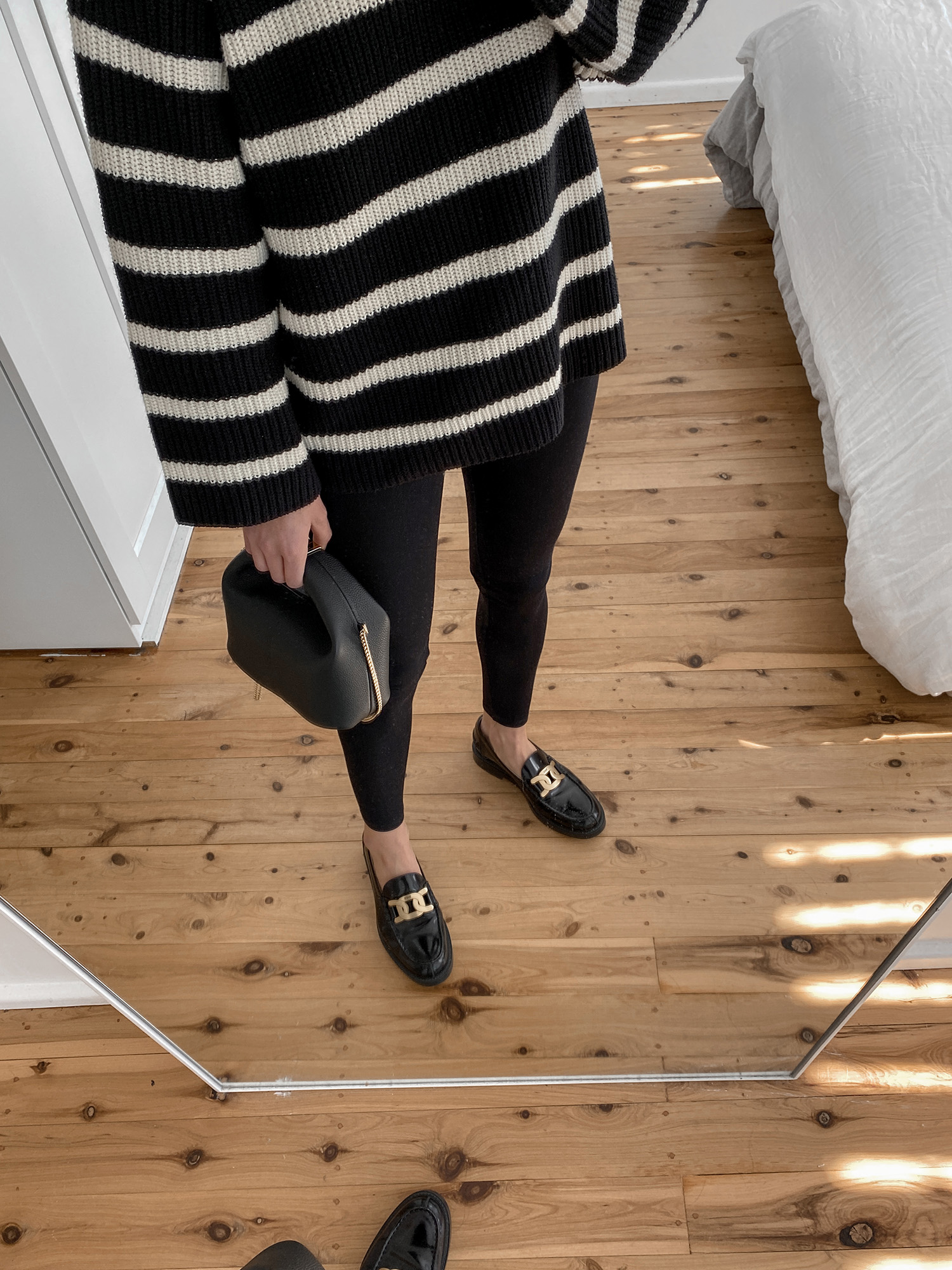 Minimal Parisian Style Outfit wearing striped knit with leggings and chunky loafers