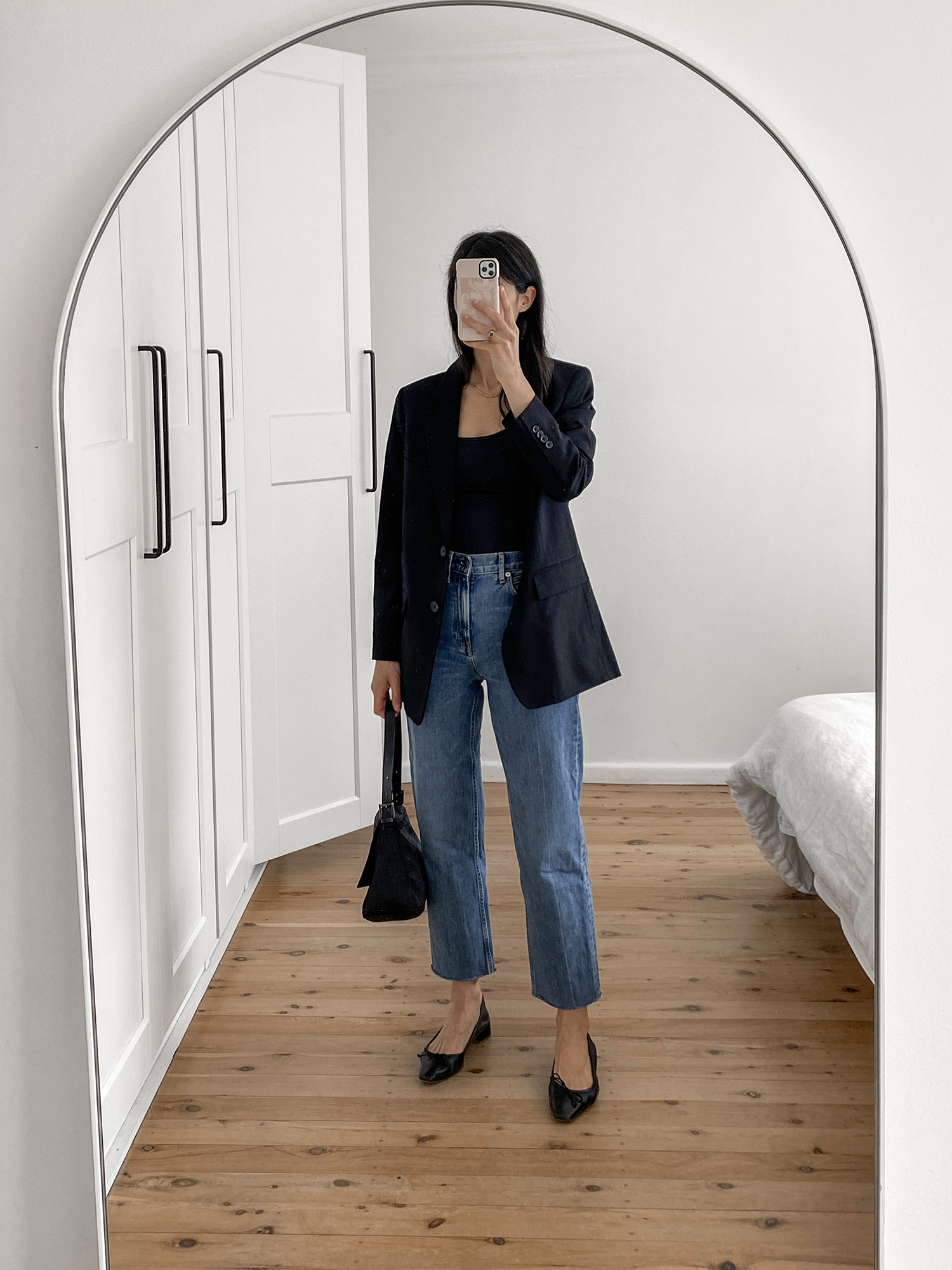 minimal outfit wearing Everlane black blazer and way high jeans