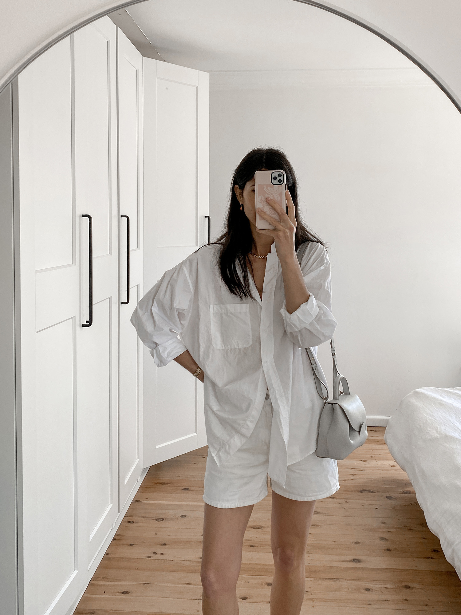 monochrome outfit summer style wearing oversized white shirt and Arket denim shorts