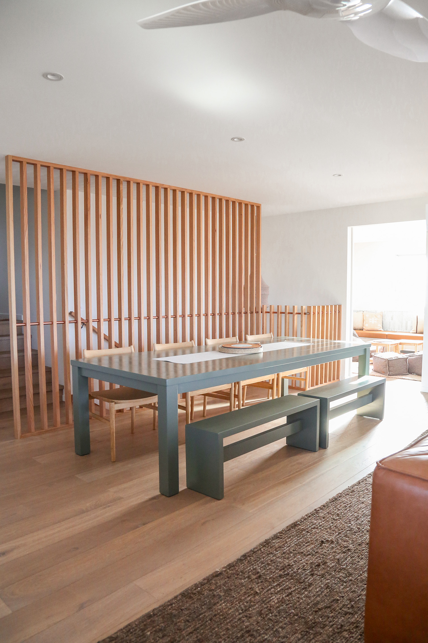 Scandi chic coastal dining space green table and chairs