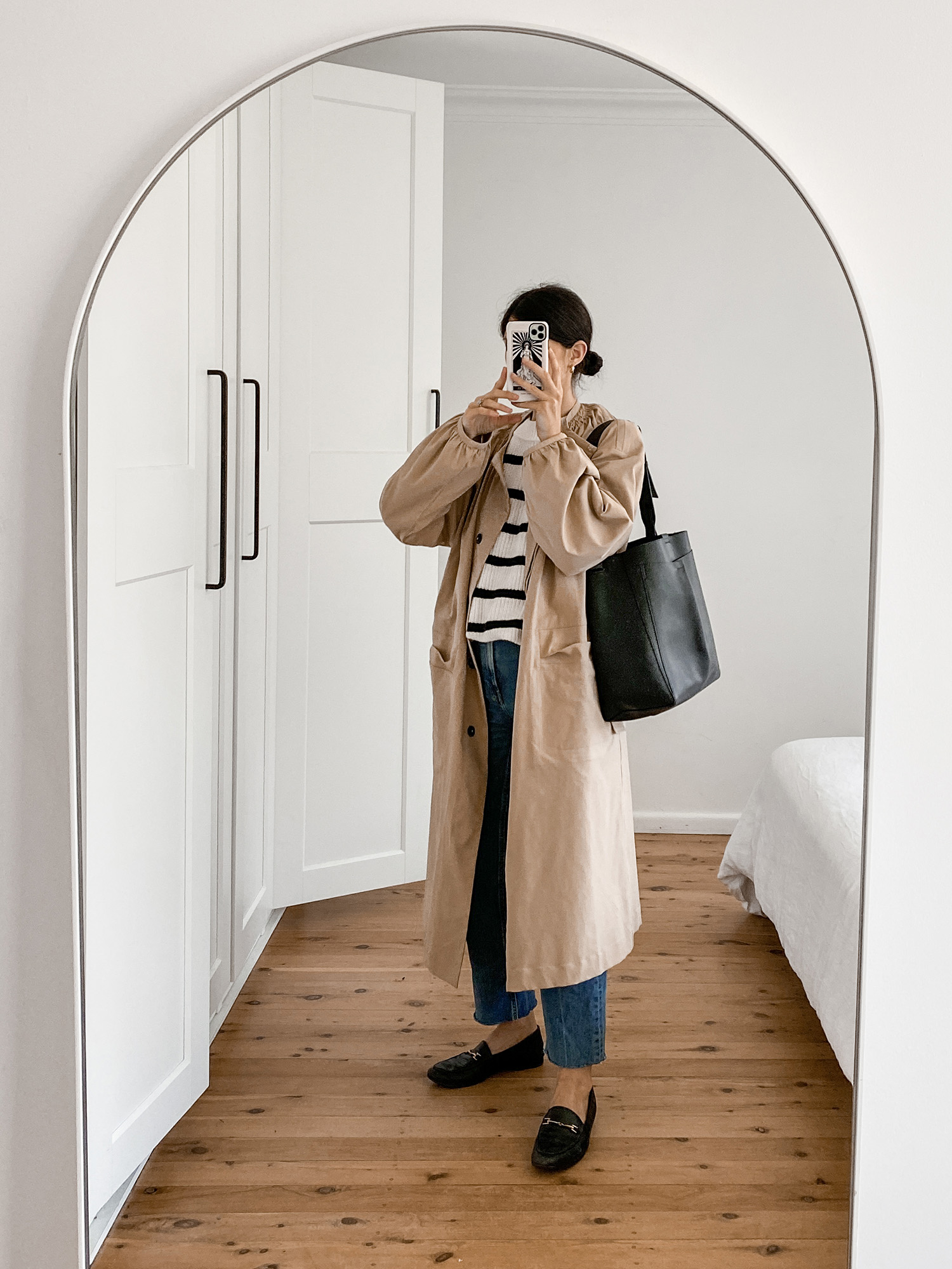 Parisian style outfit wearing Mute by JL trench coat and Everlane Way High Jeans