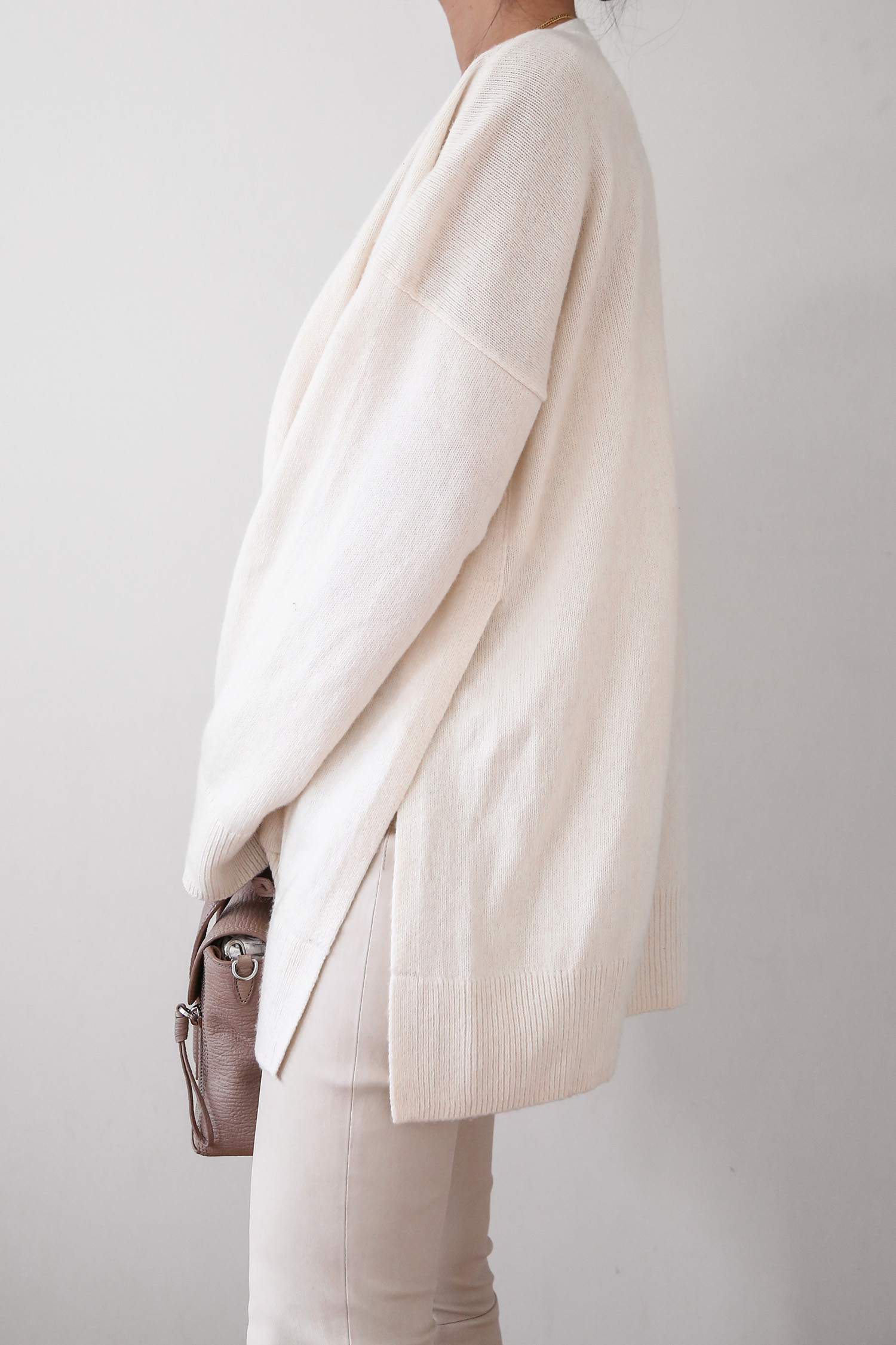 Dissh strapless top with Arket wool cardigan and leather trousers creamy toned neutrals