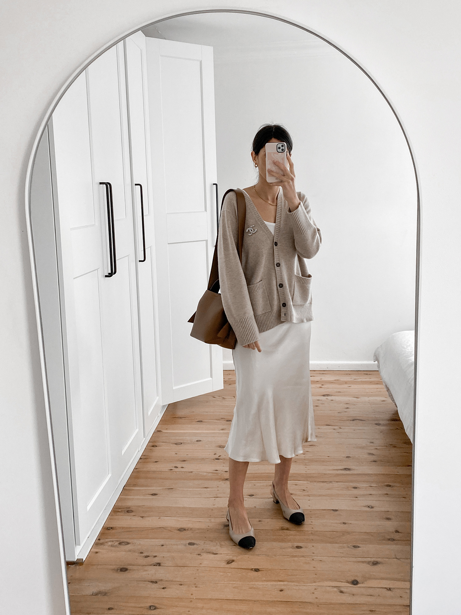 Neutral toned outfit with oversized cashmere cardigan and slip skirt