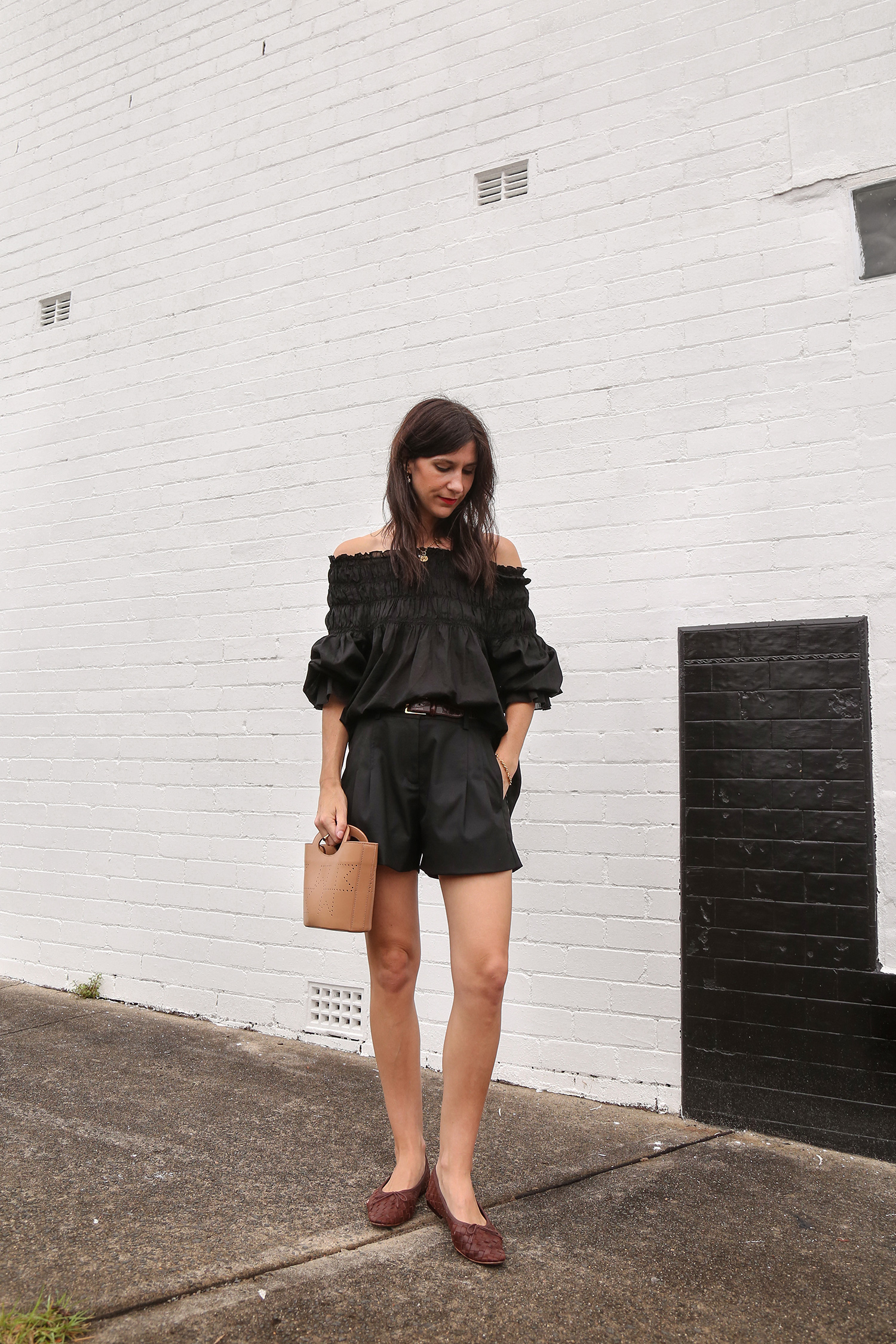 All black outfit wearing Karen Walker top with shorts and bag