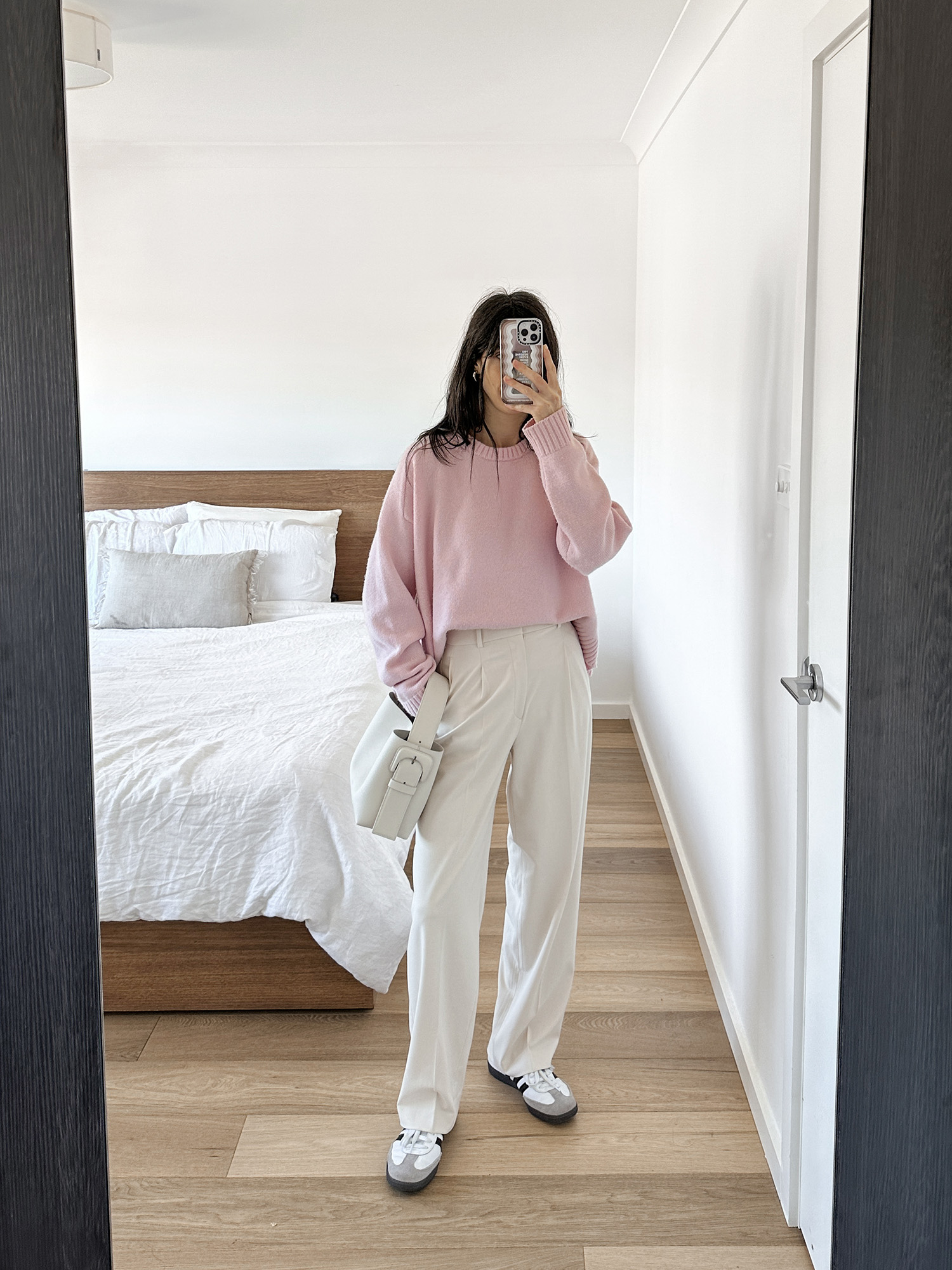 Pink sweater with cream trousers and Adidas samba sneakers