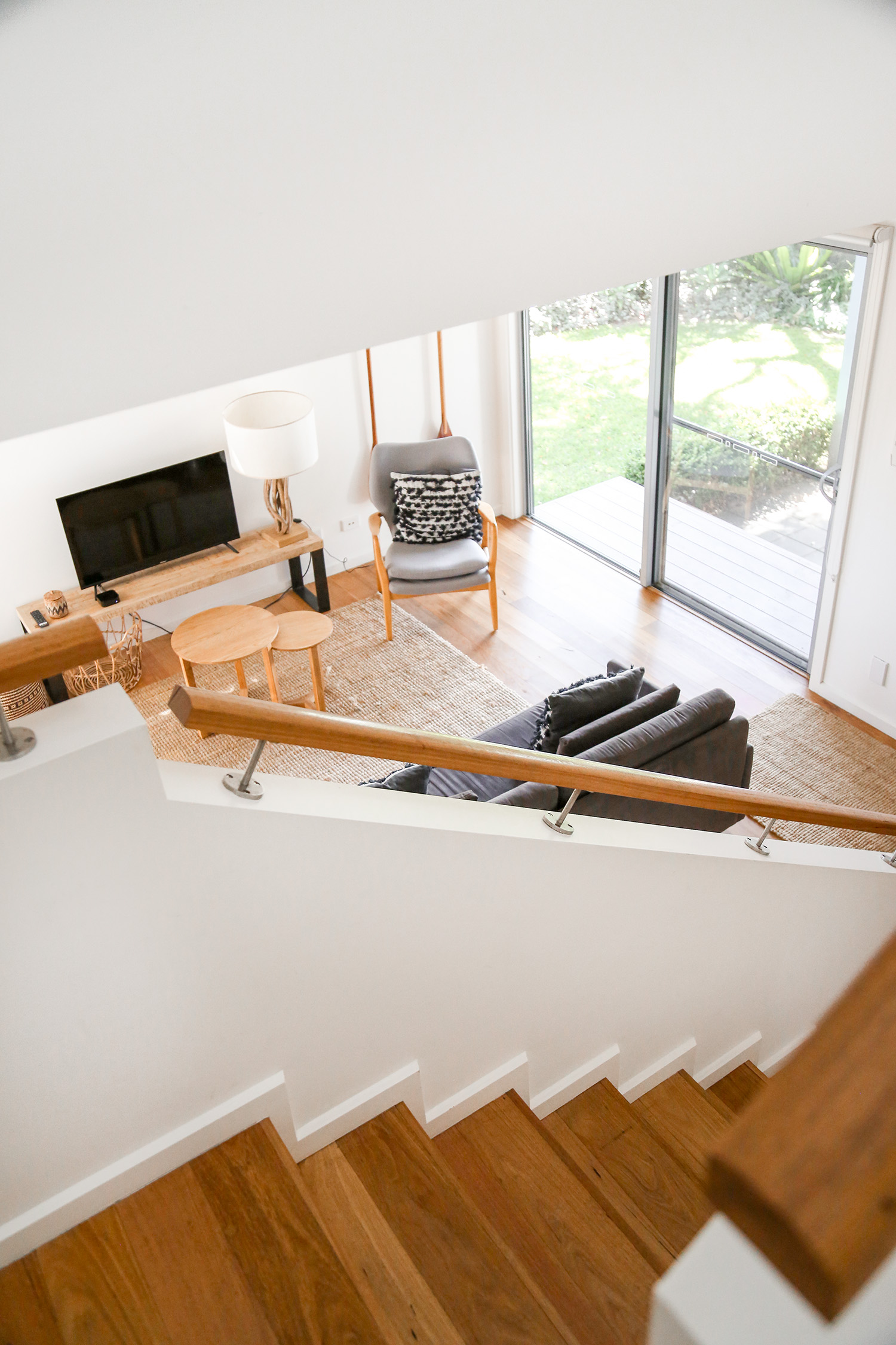 Wooden staircase and coastal living room