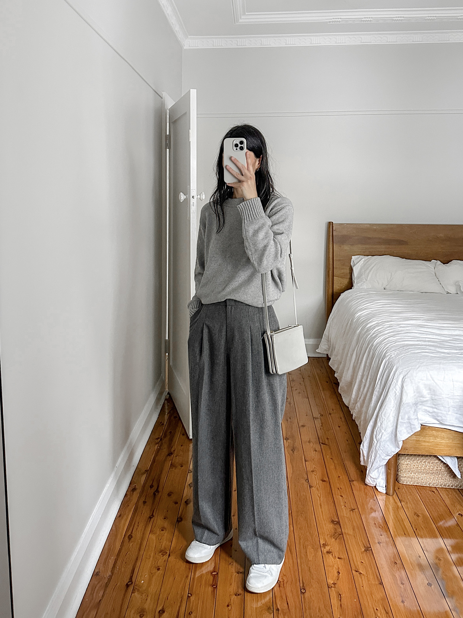 Grey monochrome outfit wearing Jenni Kayne oversized sweater with FRONTROW trousers