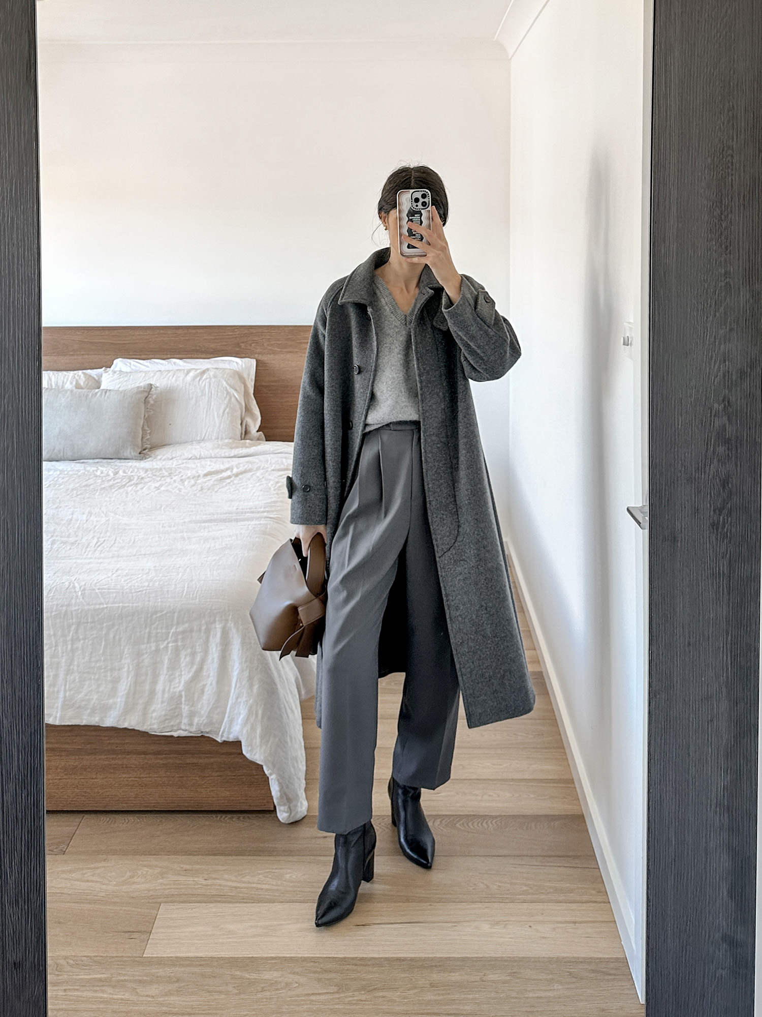 Grey monochromatic outfit wearing Nothing Written pound sweater and Frankie Shop bea trousers