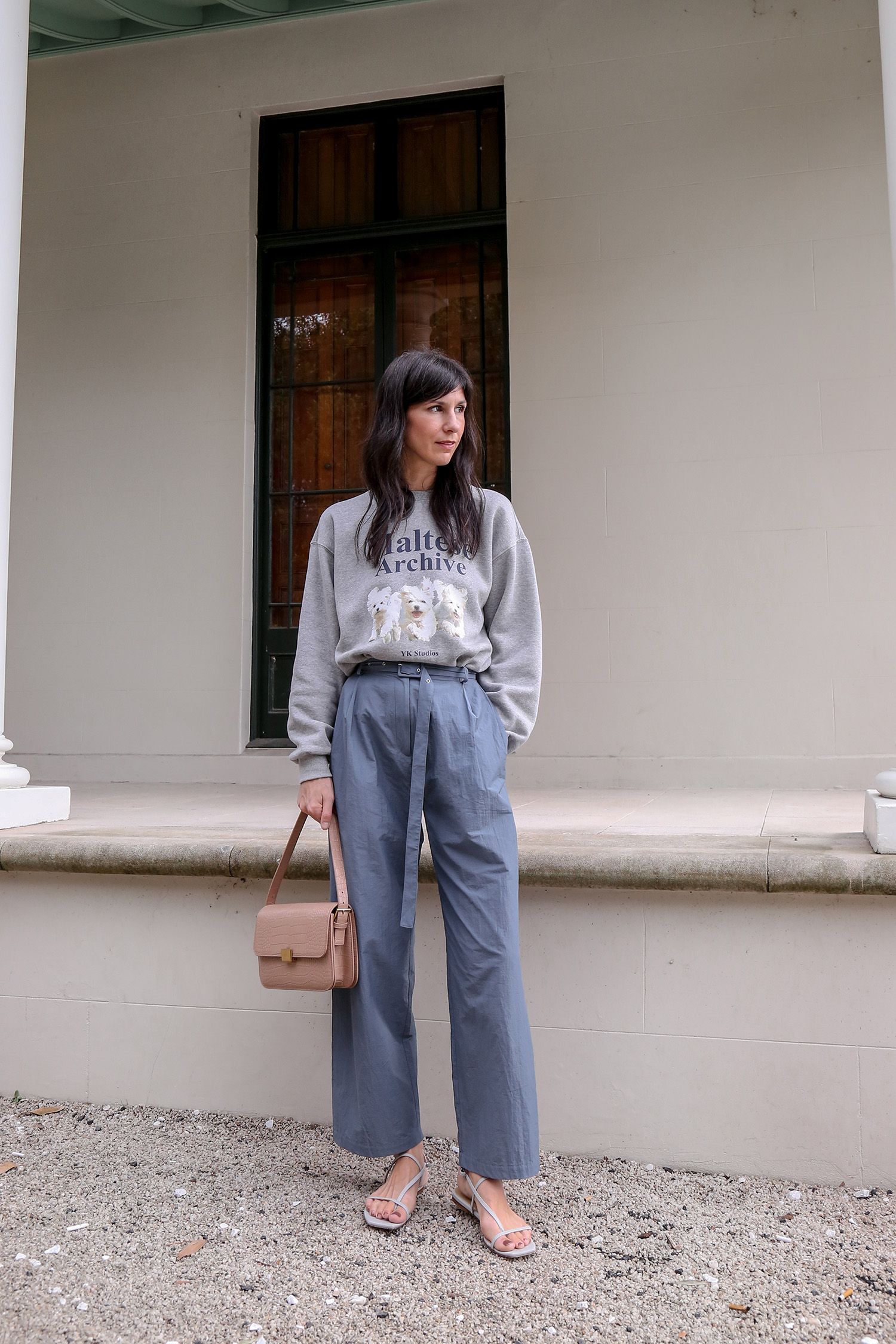 Wearing grey Maltese pup sweatshirt with blue trousers