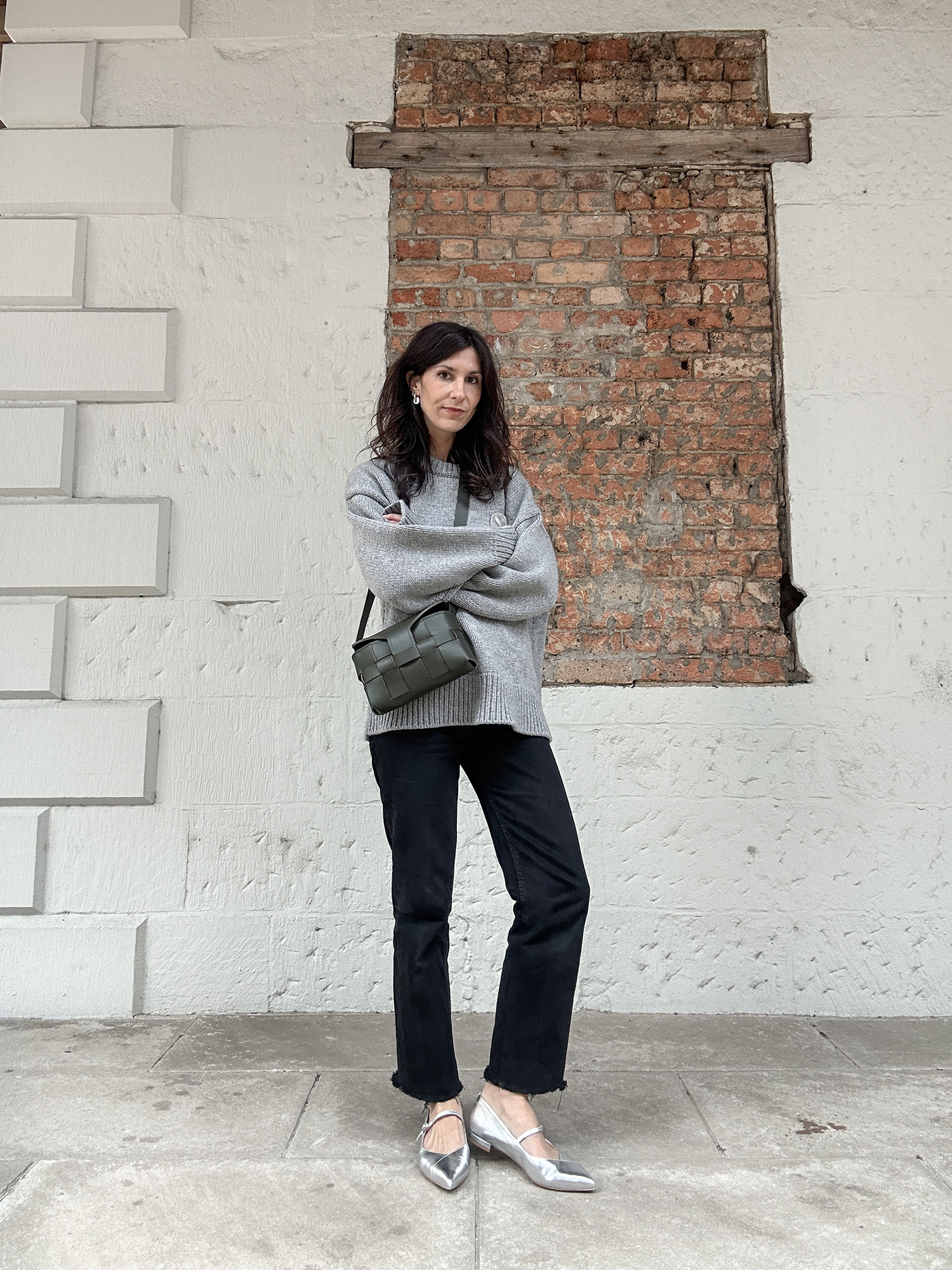 Minimalist style wearing oversized grey sweater with silver flats