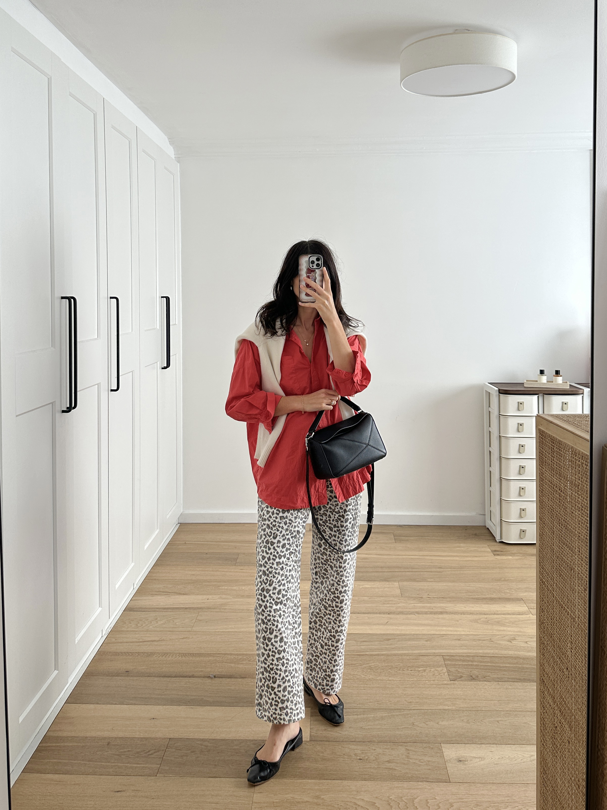 Styling leopard print jeans with a bright red oversized shirt