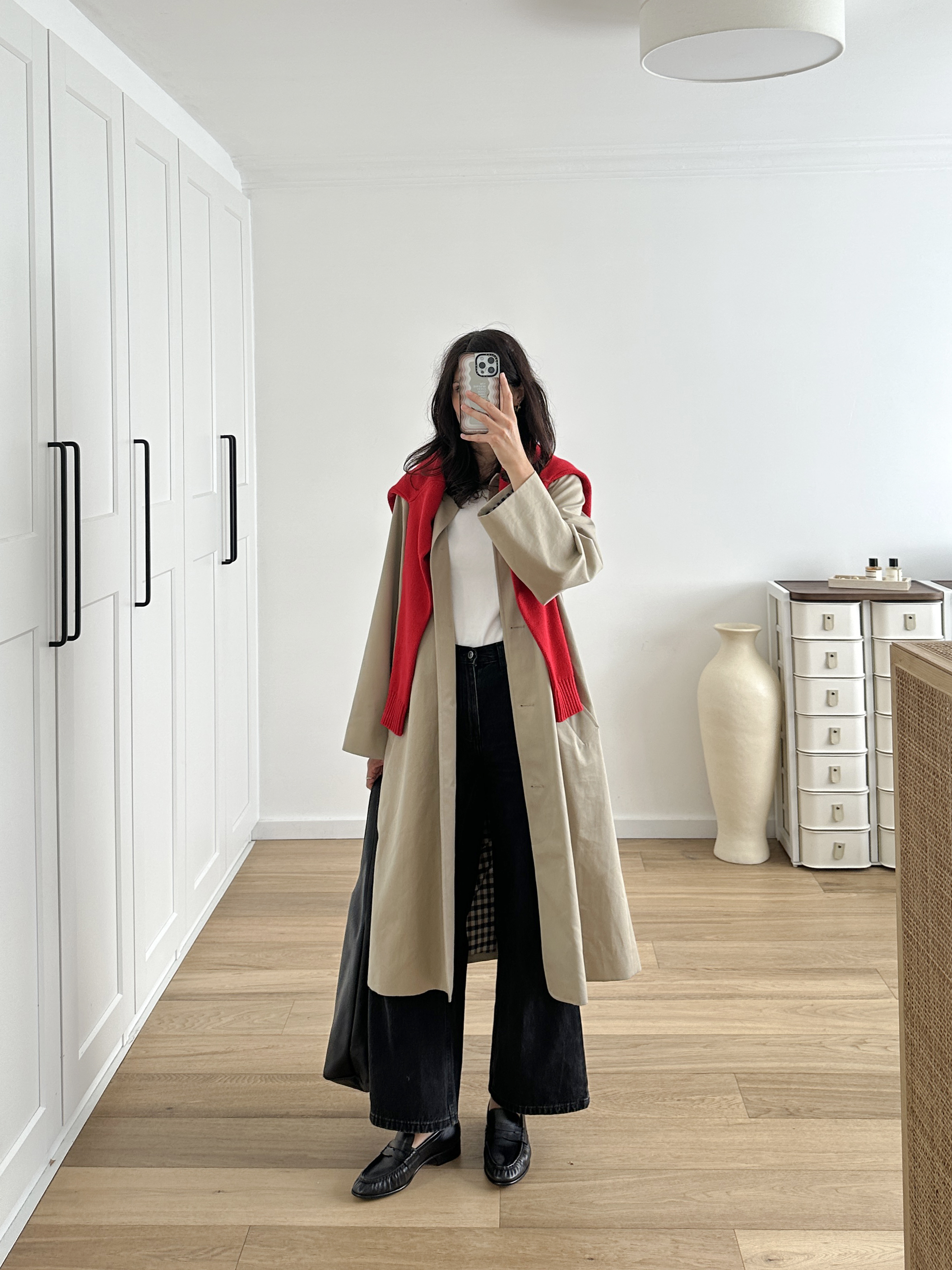 Bold red cardigan worn over the shoulders