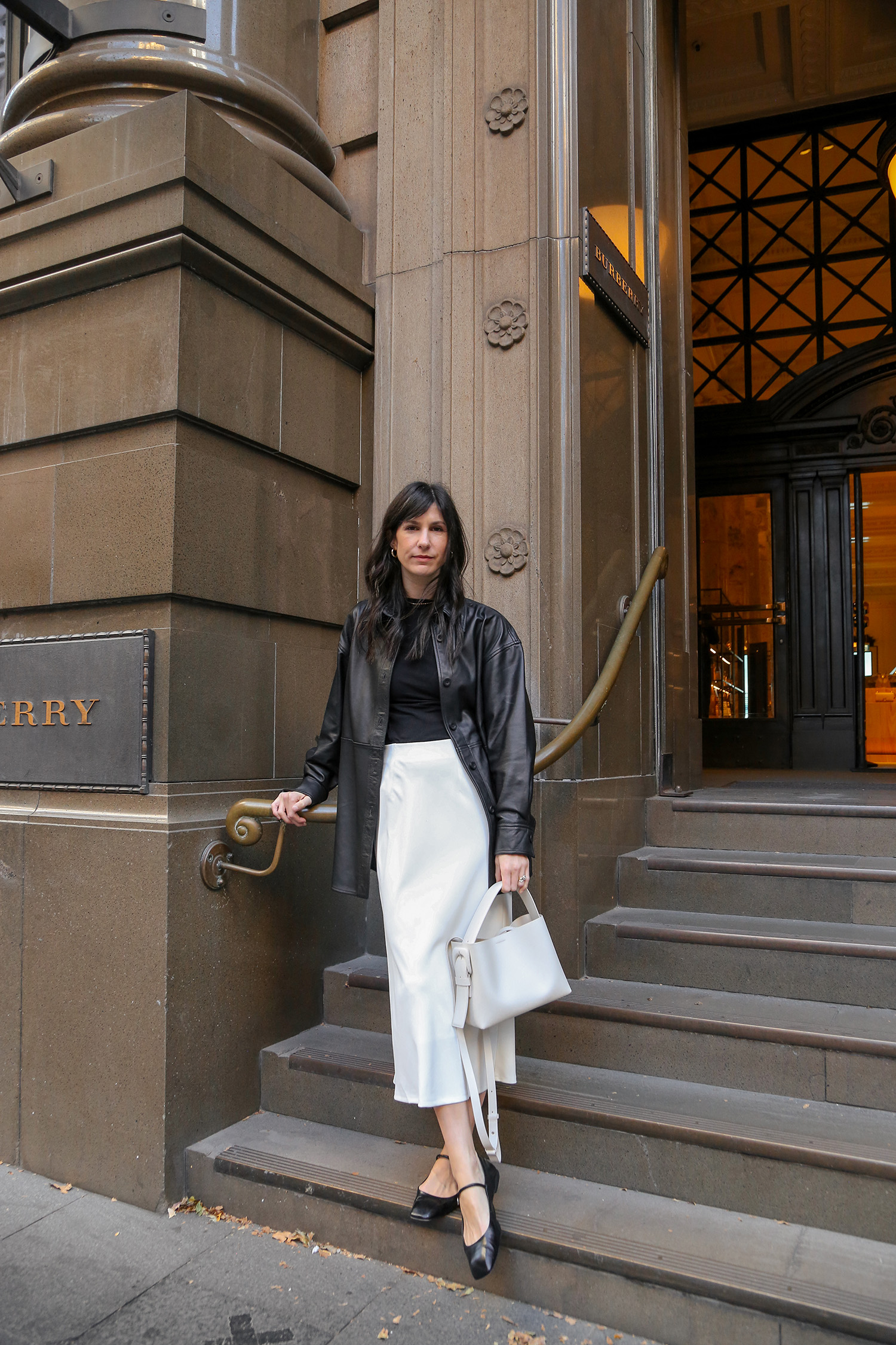 Black leather shirt with white midi skirt and Aeyde Uma flats