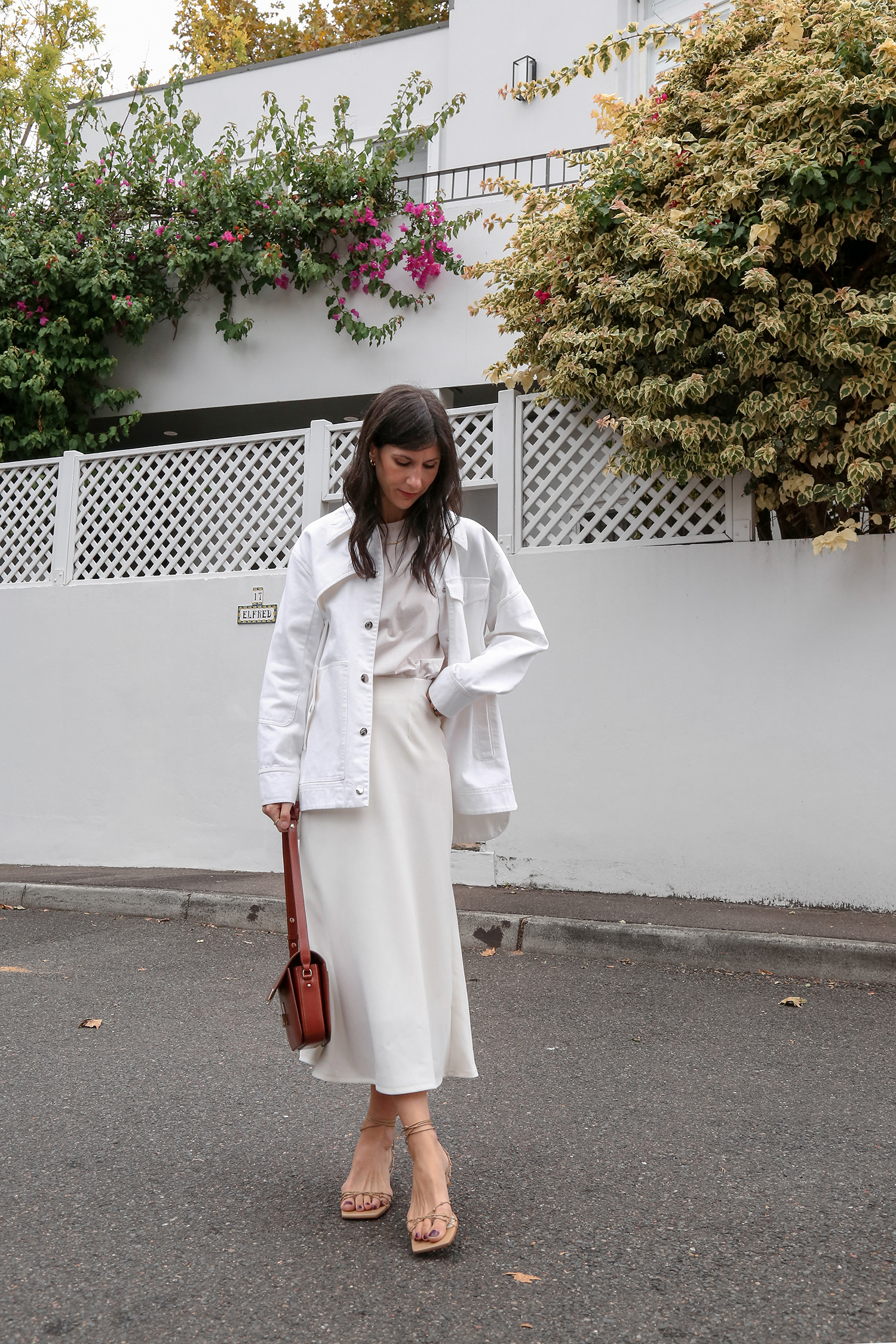 Marks and Spencer white midi skirt with Tibi denim shacket and Sezane milo bag